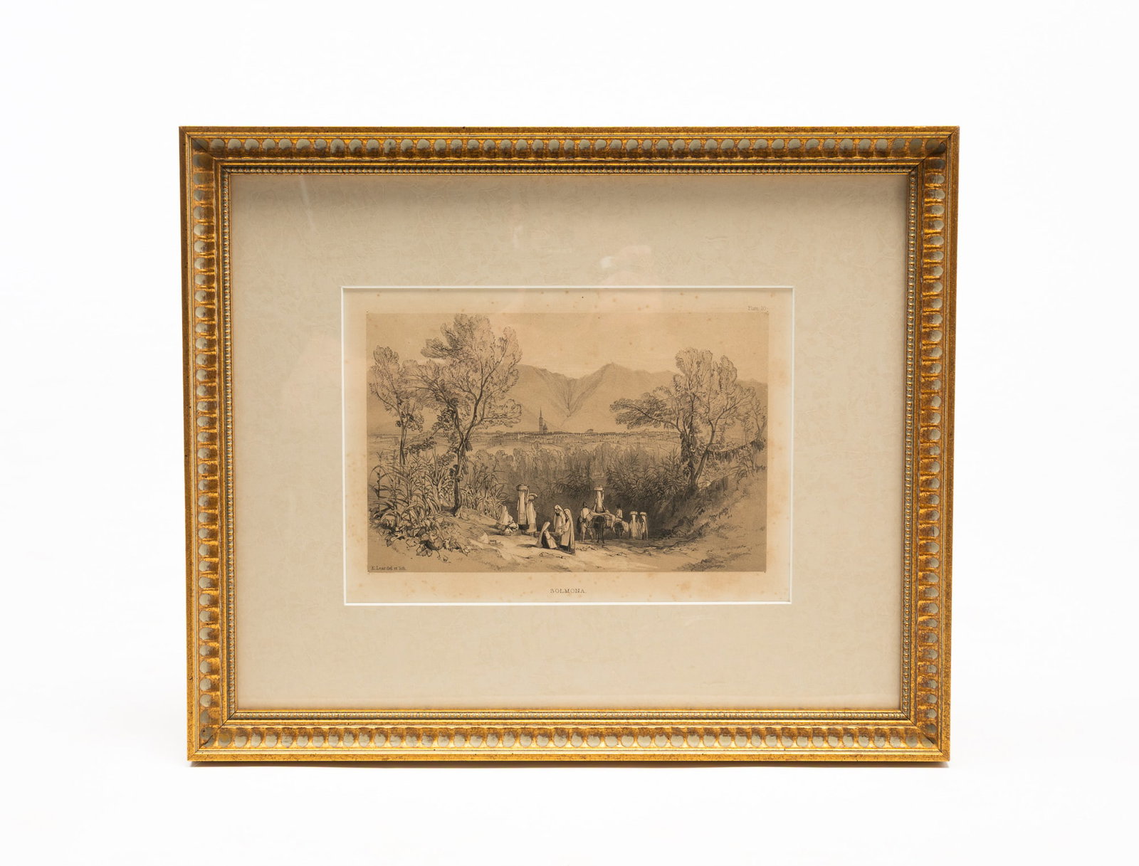 AFTER EDWARD LEAR (ENGLISH, 1812-1888) "SOLMONA" LITHOGRAPH.: 19th Century. View of a town in the distance with people walking down a path. Title inscribed in plate. Matted and framed behind glass. Frame, 15.5"h. 18.75"w.