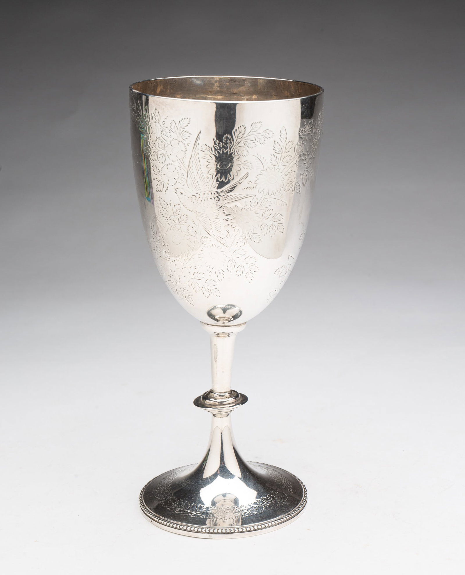OVERSIZE SHEFFIELD STERLING SILVER GOBLET VASE.: English, Fourth quarter 19th Century. Knob stem, foot with beaded edge, and overall floral engraved decoration. Datemark for 1891. 9"h. 4"d. Approximately 9 ozt.**Note: Bidders who are not yet establi