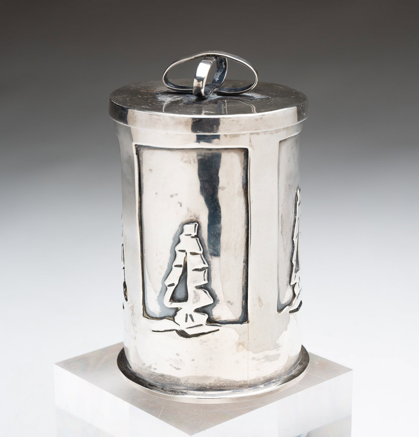 AMERICAN STERLING SILVER LIDDED CANNISTER.: 20th Century. Cylindrical jar with ships on the side and a bow at the top of the lid. 4.75"h. Approximately 10.4 ozt.**Note: Bidders who are not yet established with our firm will be required to pay