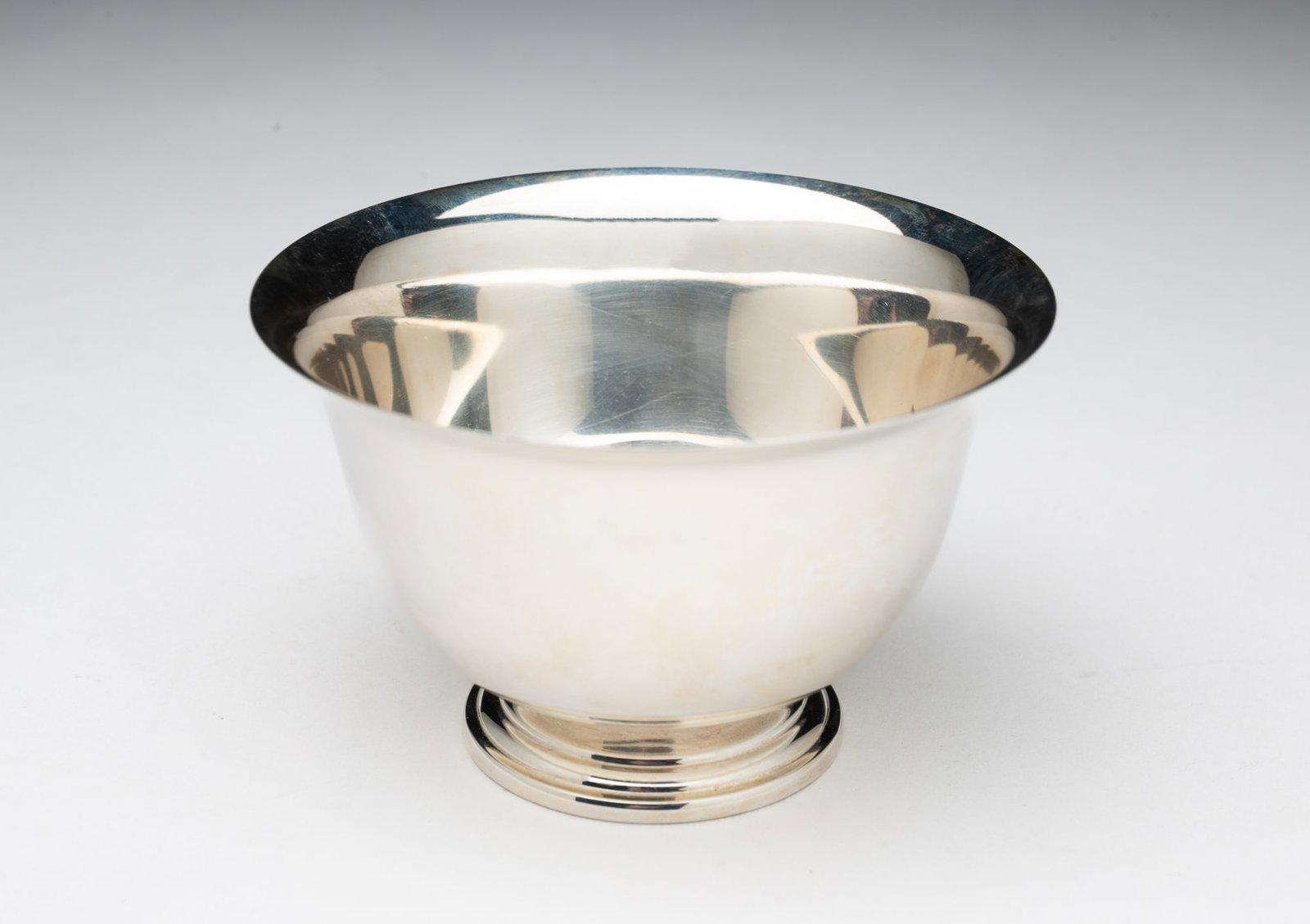 CARTIER "PAUL REVERE REPRODUCTION" STERLING SILVER FOOTED BOWL.: 20th Century. Footed bowl with typical shape bowl with flared lip and marked to bottom "Cartier Sterling Paul Revere Reproduction 803". 2.25"h. 3.5"w. Approximately 2 ozt.**Note: Bidders who are not