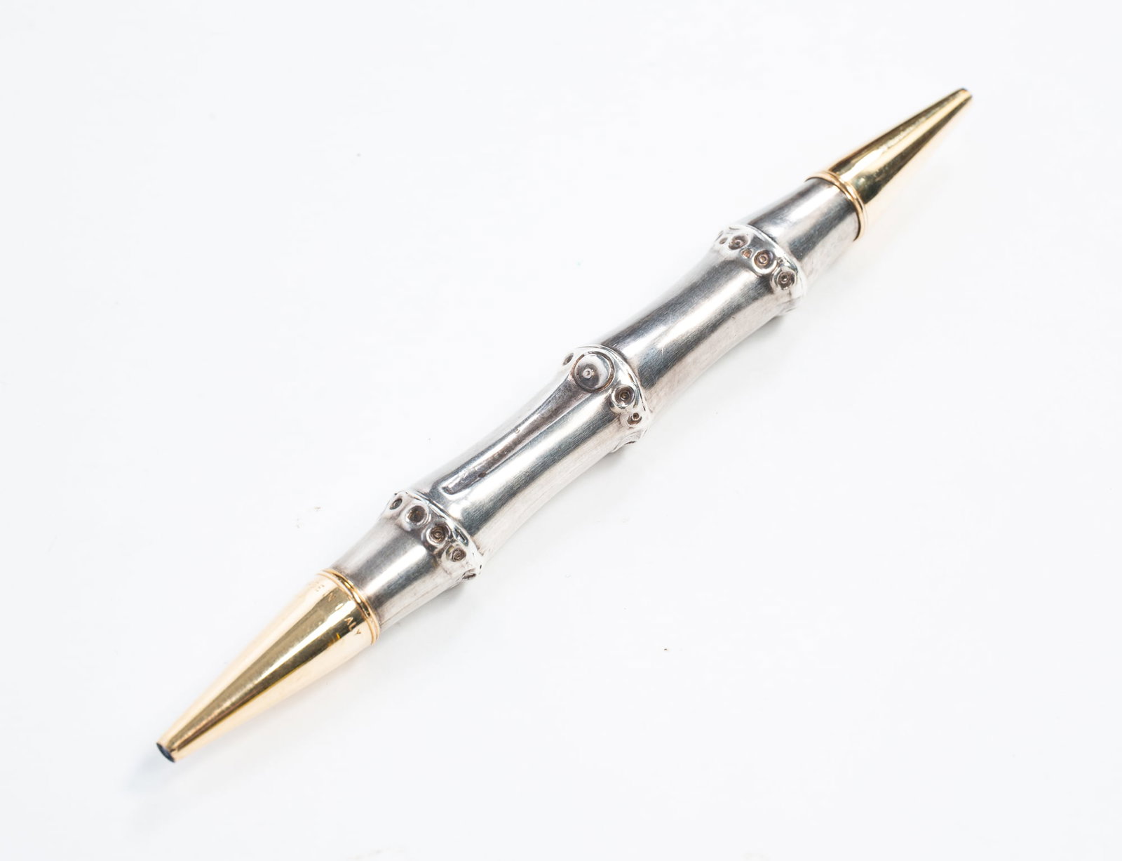 GUCCI STERLING SILVER DOUBLE-ENDED BAMBOO MECHANICAL PENCIL.: Italian, 20th Century. Bamboo motif body with twisting ends. Marked "Gucci Made in Italy". 6.5"l.**Note: Bidders who are not yet established with our firm will be required to pay for jewelry, coins,