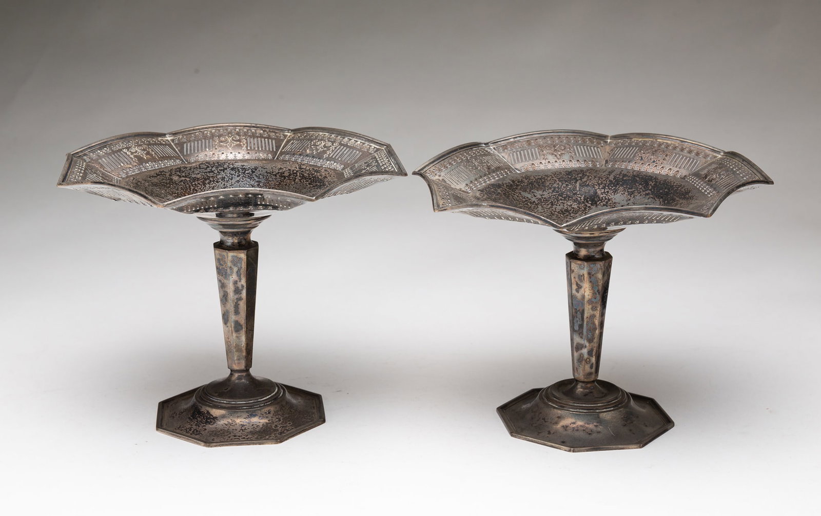 PAIR OF AMERICAN STERLING SILVER RETICULATED TAZZAS.: 20th Century. Octagonal bases with fluted standards and shaped, reticulated edges. 6"h. 7.5"w. Approximately 17 ozt.**Note: Bidders who are not yet established with our firm will be required to pay