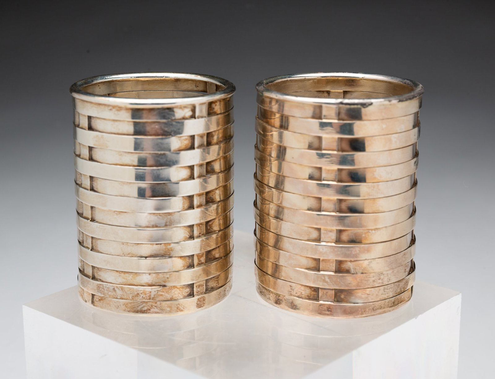 TWO TIFFANY & CO. STERLING SILVER TOOTHPICK HOLDERS.: Italian, 20th Century. Cylindrical basketweave pattern holders, marked to inside bottoms, "Tiffany & Co. 925 Sterling Italy". 2"h. Approximately 2.8 ozt.**Note: Bidders who are not yet established