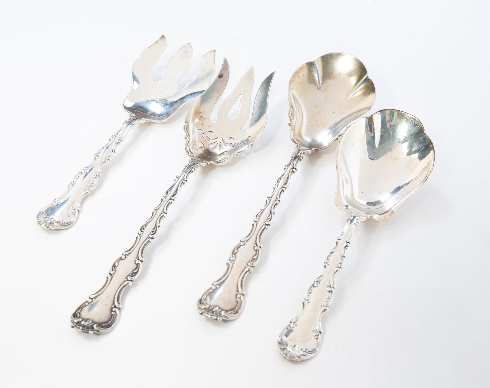 TWO GORHAM "STRASBOURG" PATTERN STERLING SILVER SALAD SETS.: American, pat. 1897. Larger pair, 10.5"l. Second pair, 8.75"l. Approximately 13 ozt.**Note: Bidders who are not yet established with our firm will be required to pay for jewelry, coins, and precious