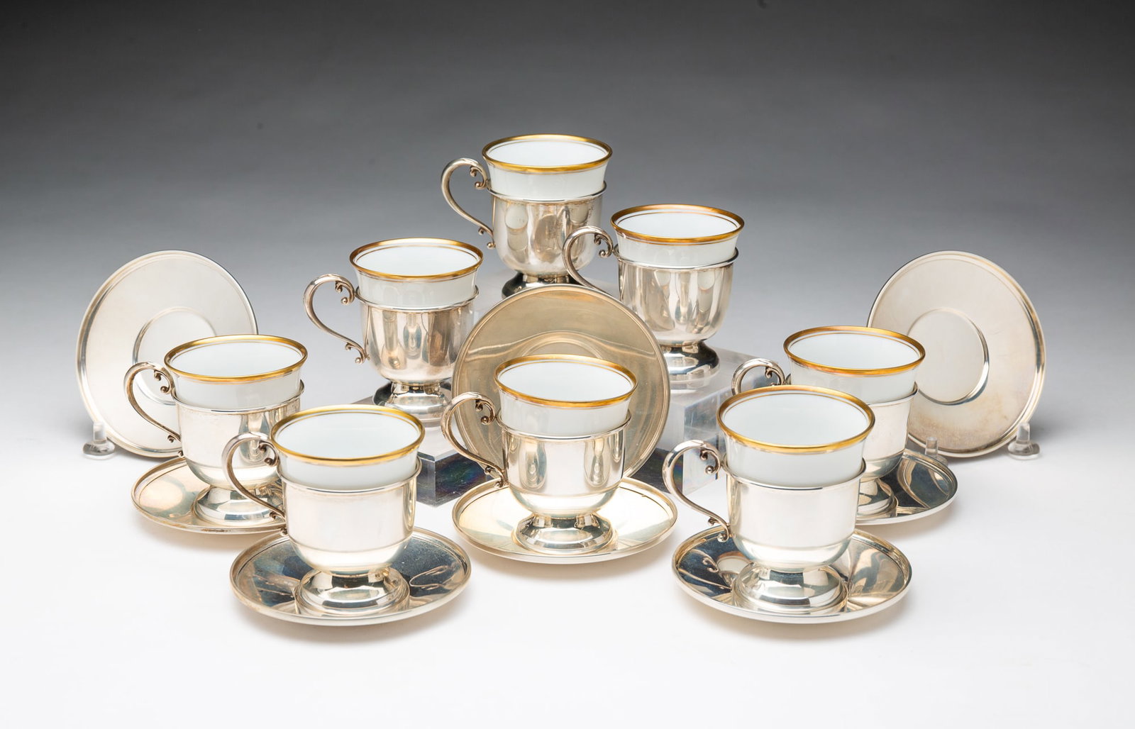 EIGHT CARTIER STERLING SILVER DEMITASSE CUPS AND SAUCERS WITH HUTSCHENREUTHER PORCELAIN INSERTS. (1 of 4)