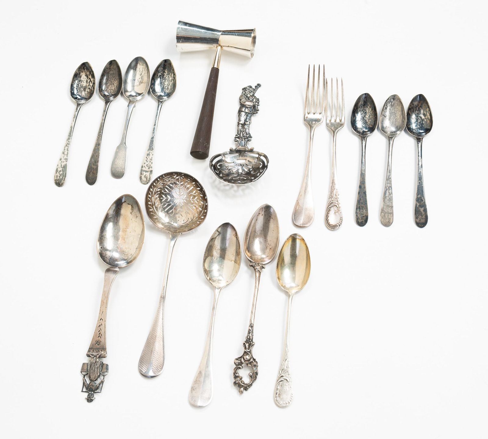 GROUP OF SIXTEEN STERLING SILVER ACCESSORIES.: Mexican, European, and English. A Mexican wood-handled jigger, caster spoons, forks, teaspoons, and other utensils. Approximately 14.2 ozt. excluding the jigger.**Note: Bidders who are not yet