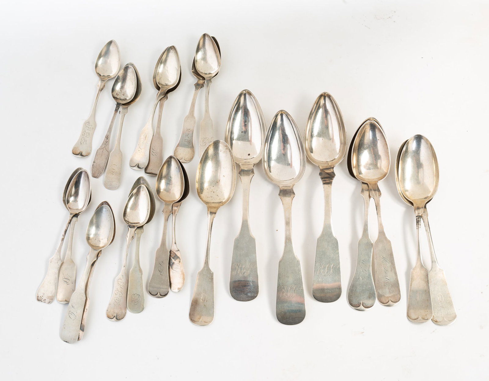 TWENTY-THREE AMERICAN COIN SILVER SPOONS.: Mid-19th Century. Includes fifteen teaspoons, five tablespoons, and three serving spoons. Featuring J. Wallace, Duhme, Crittenden, N. Harding, J&A Gardiner. Largest, 9"l. Approximately
