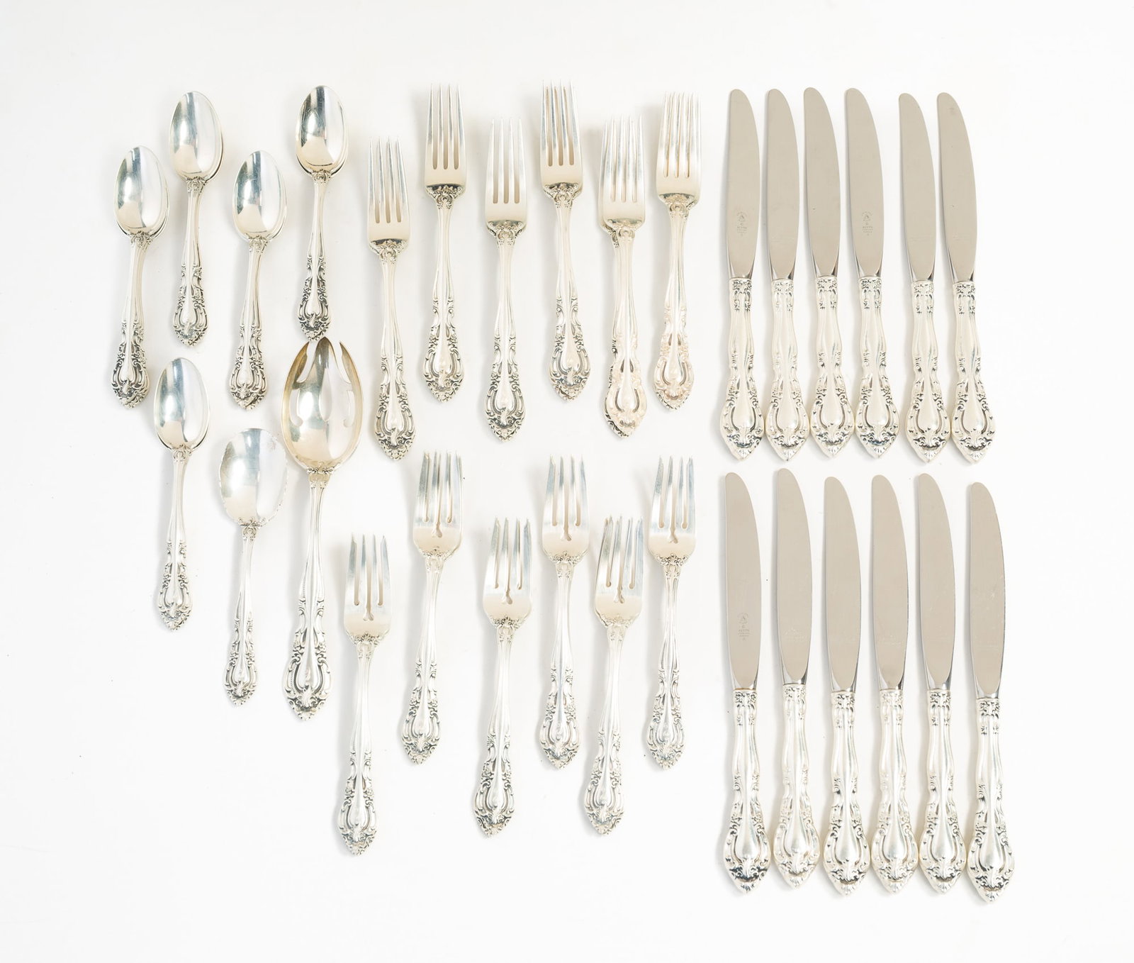 ALVIN "VALVADI" STELRING SILVER FLATWARE SET.: American, pat. 1966. Includes twelve dinner knives, eleven teaspoons, twelve salad forks, twelve dinner forks, a sugar spoon, and a pierced serving spoon. Approximately 43.8 ozt. excluding hollow