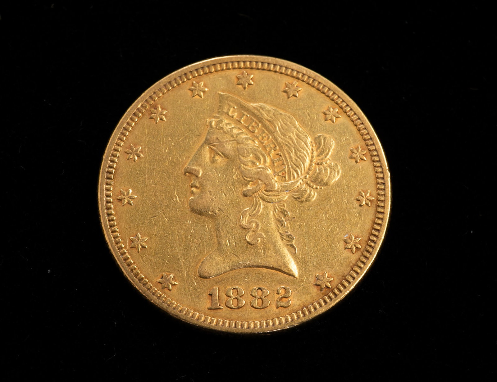 1882 TEN DOLLAR GOLD LIBERTY HEAD COIN. (1 of 2)