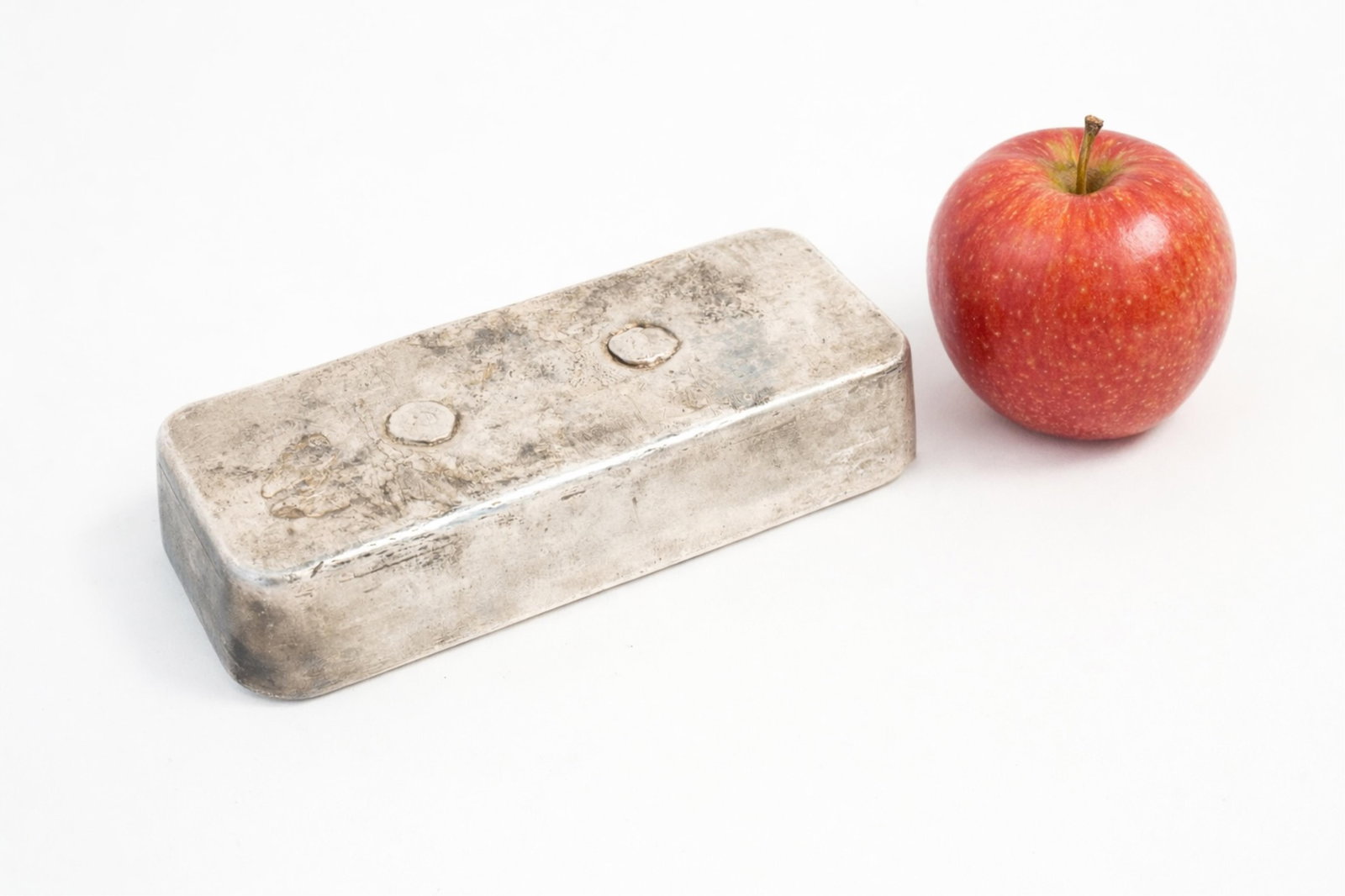 JOHNSON MATTHEY .999 FINE SILVER 100 oz. BAR.: Canadian, 20th Century. The poured bar of rectangular form with rounded corners, and stamped "JOHNSON MATTHEY", "100+ oz", "999+", Assay officemark, and the serial number "A228346". Approximately 109