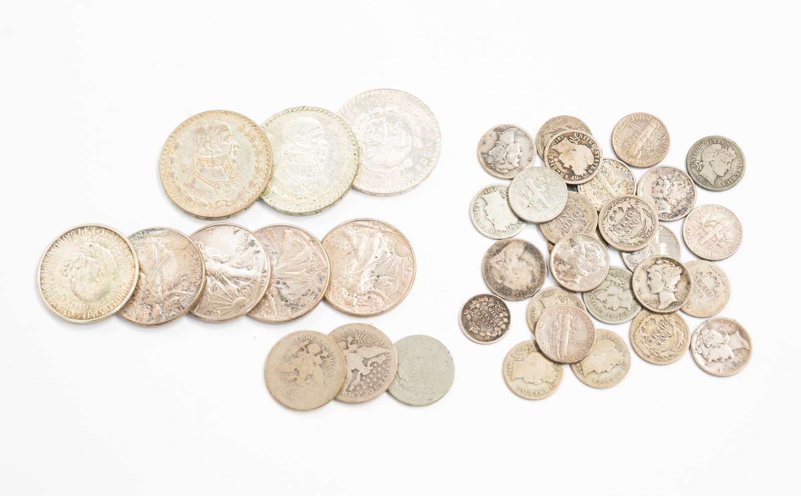 GROUP OF SILVER COINAGE.: American, 20th Century. Includes Mexican pesos, Walking Liberty coins, mercury dimes, Roosevelt dimes, a sixpence, Barber dimes, Barber half dollars, and a Canadian five-cent coin. Approximately 6.6oz