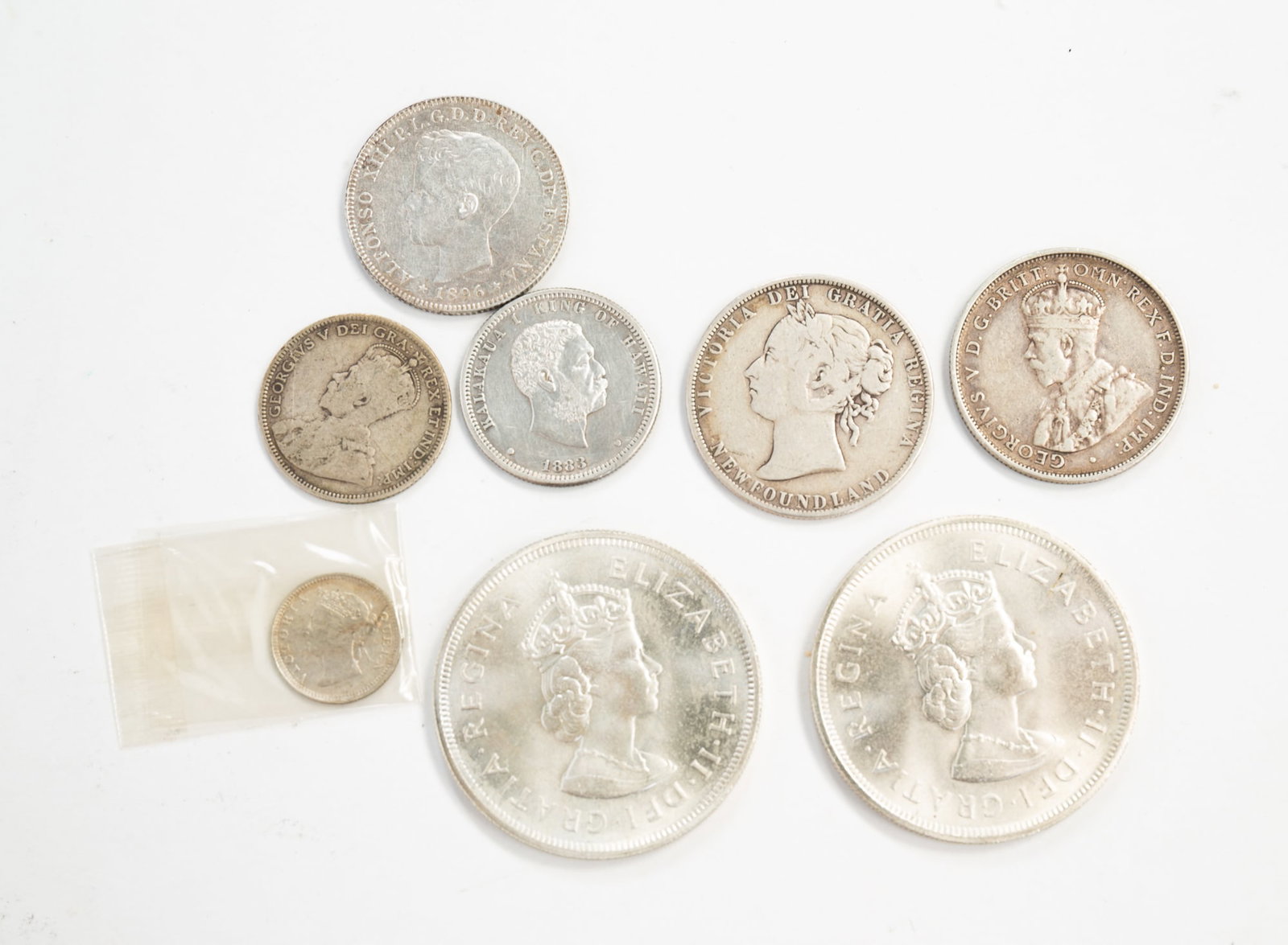GROUP OF COINS FROM HAWAII, PUERTO RICO, BERMUDA, NEWFOUNDLAND AND MORE.: Group of coins from Hawaii, Puerto Rico, Bermuda, Newfoundland and Australia from the first half of the 20th century and earlier. *We do not grade or qualify coin condition, nor do we weigh currency t
