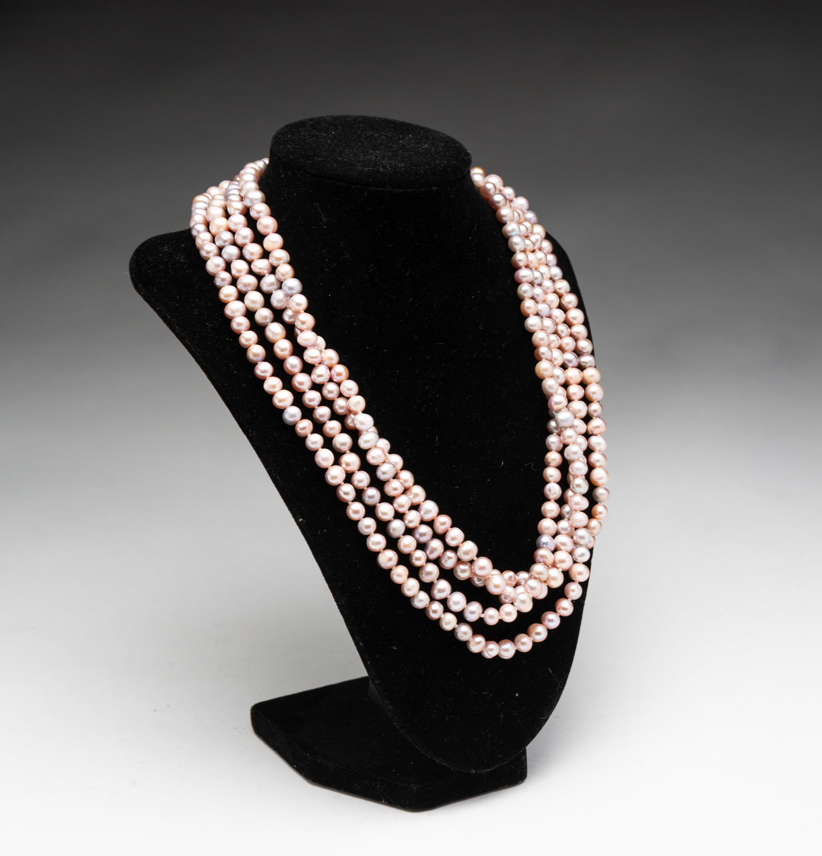 OPERA LENGTH STRAND OF PEARLS.: 20th Century. Knotted strand of freshwater pearls consisting of well-matched 7.5 to 8mm pearls. 80"l. 40" drop.**Note: Bidders who are not yet established with our firm will be required to pay for