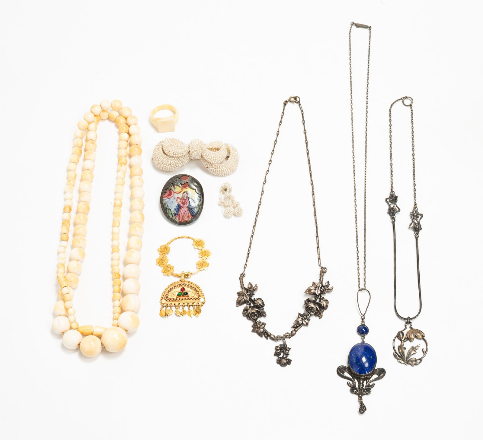 COLLECTION OF LADIES' JEWELRY.: American and European,19th-early 20th Century. A silver-toned Art Nouveau pendant necklace with lapis lazuli cabochon. Two silver necklaces with flowers. An 800 silver and enameled brooch, 0.36 ozt.