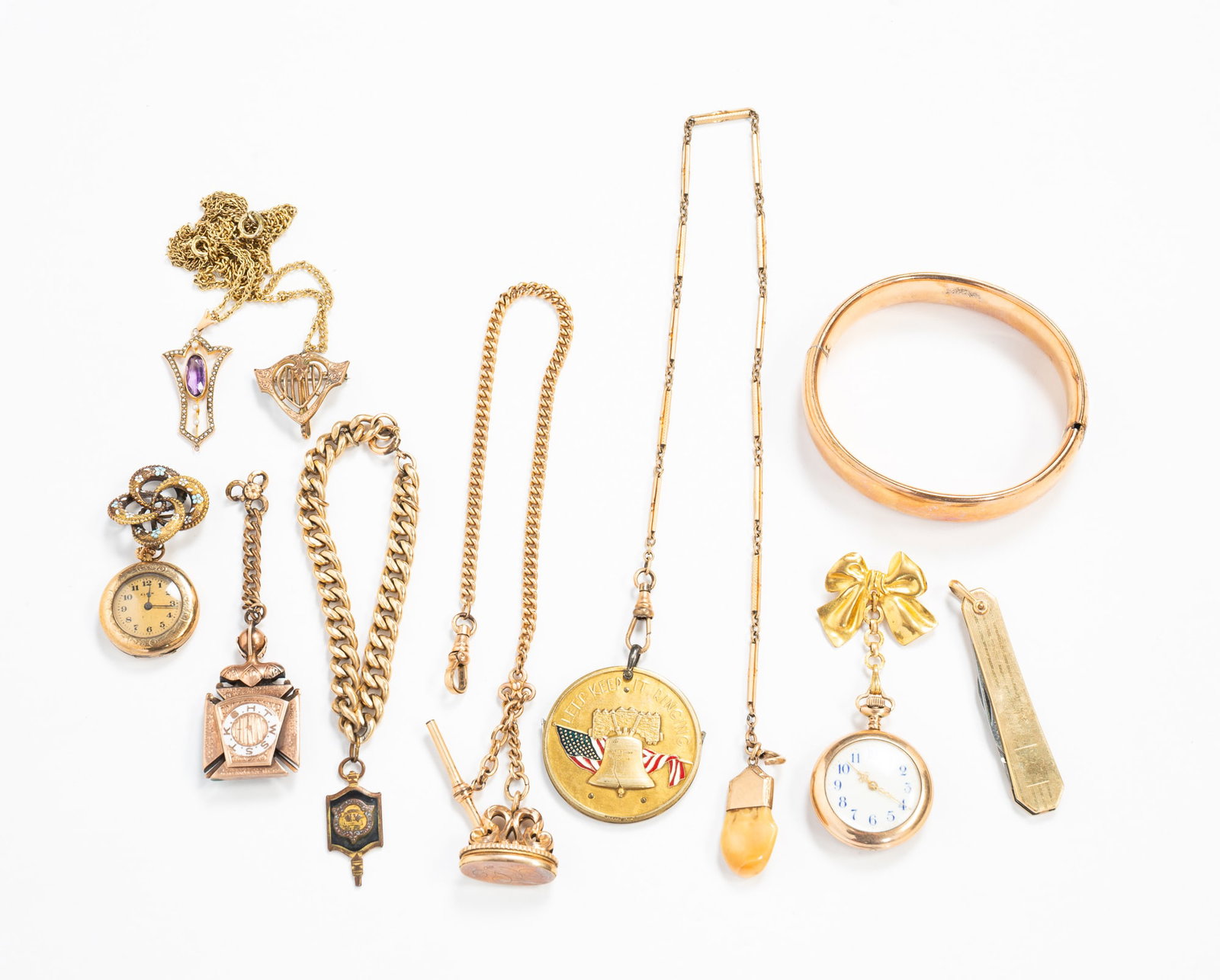 GROUP OF VICTORIAN GOLD-FILLED JEWELRY AND ACCESSORIES.: Includes watch fobs, bracelets, a necklace with a seed pearl and purple stone pendant, 17"l., a pocket knife, a Lodge pendant, and two brooches with watches.**Note: Bidders who are not yet
