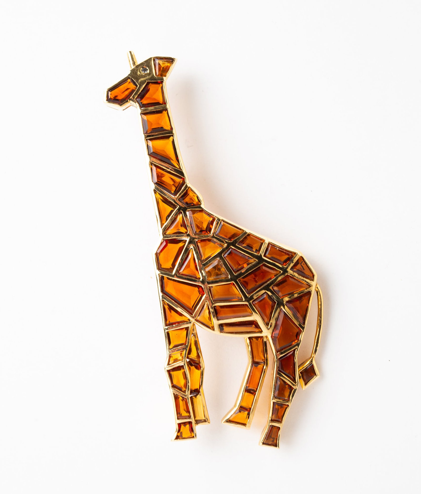 CARTIER GOLD AND CITRINE GIRAFFE BROOCH.: CARTIER GOLD AND CITRINE GIRAFFE BROOCH. Paris, 20th century. 18K yellow gold and citrine brooch designed as a charming giraffe. The body comprised of fancy cut citrines of various sizes inlaid in gol