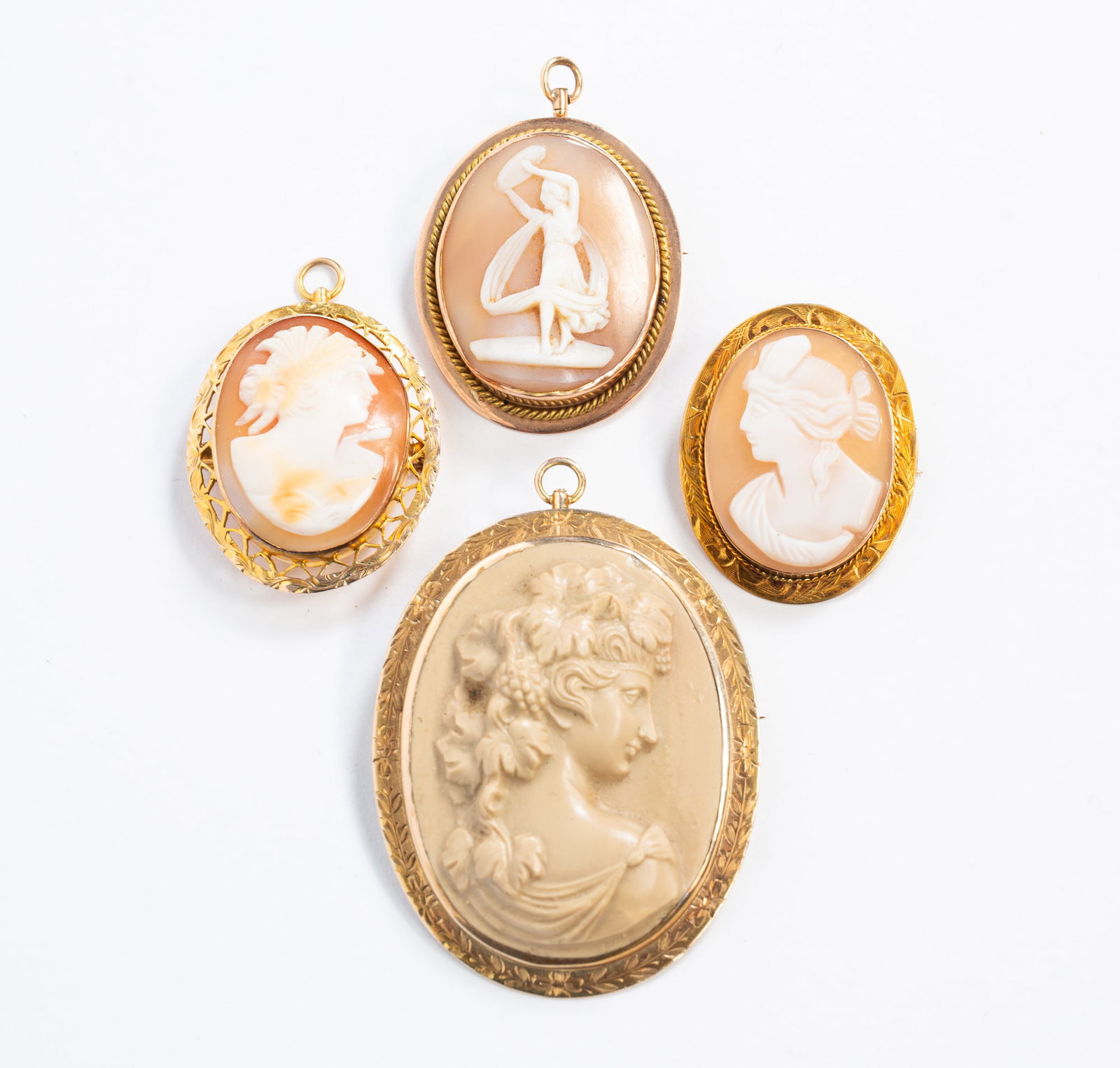 FOUR 10K GOLD FRAMED CAMEO BROOCHES. (1 of 4)