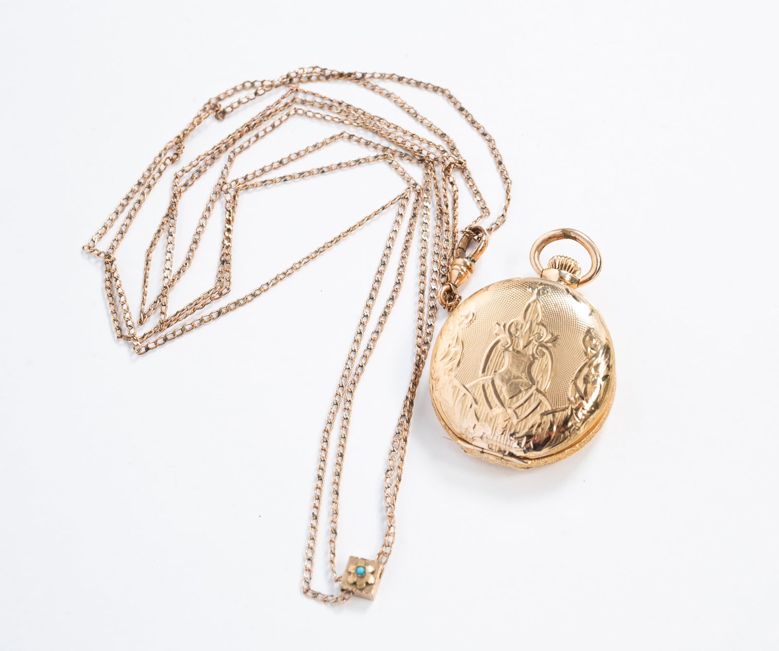 LADIES WALTHAM POCKET WATCH IN 14KT GOLD HUNTERS CASE.: 20th Century. Waltham pocket watch with porcelain face, Arabic numerals and seconds dial, serial number 15716020, in a 14k yellow gold W.W.C.Co engraved case. Also with a gold-plated watch fob with a