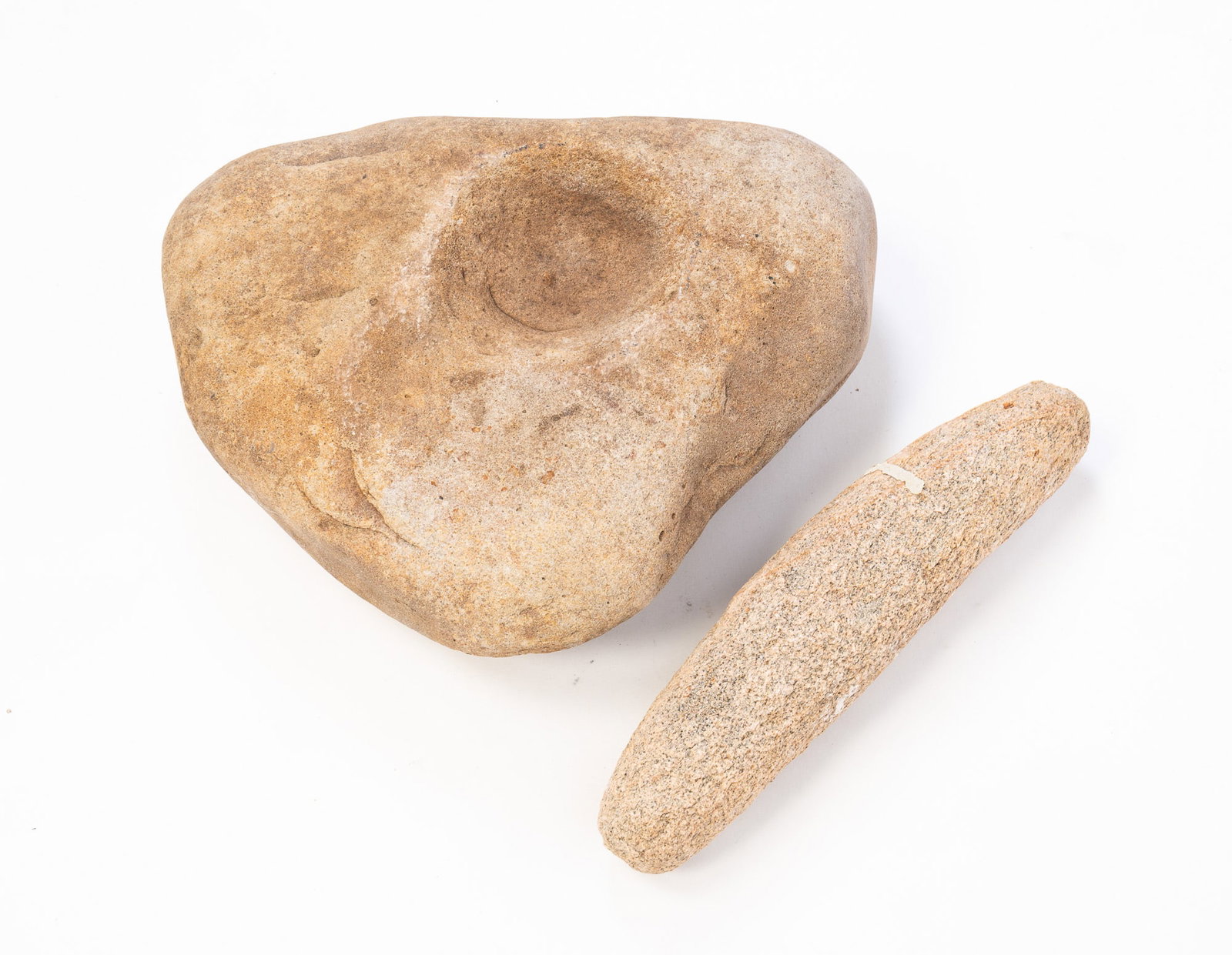 NATIVE AMERICAN GRINDING STONES.: NATIVE AMERICAN GRINDING STONES. Pink Granite grinder 12.5"l. and a double-well stone. Double-well example, 4"h. 13"w. 10"d. 12.5"l.