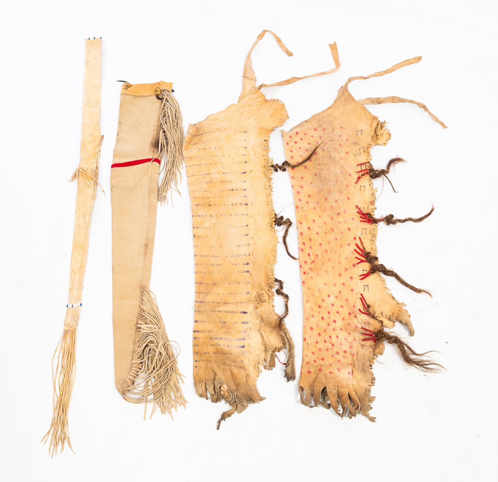 GROUP OF NATIVE AMERICAN BUCKSKIN ACCESSORIES.: GROUP OF NATIVE AMERICAN BUCKSKIN ACCESSORIES. 19th or 20th Century. Comprising a pair of painted buckskin chaps with beads and hair ornamentation, a gun case, and a quiver. Chaps, approx. 40"l.