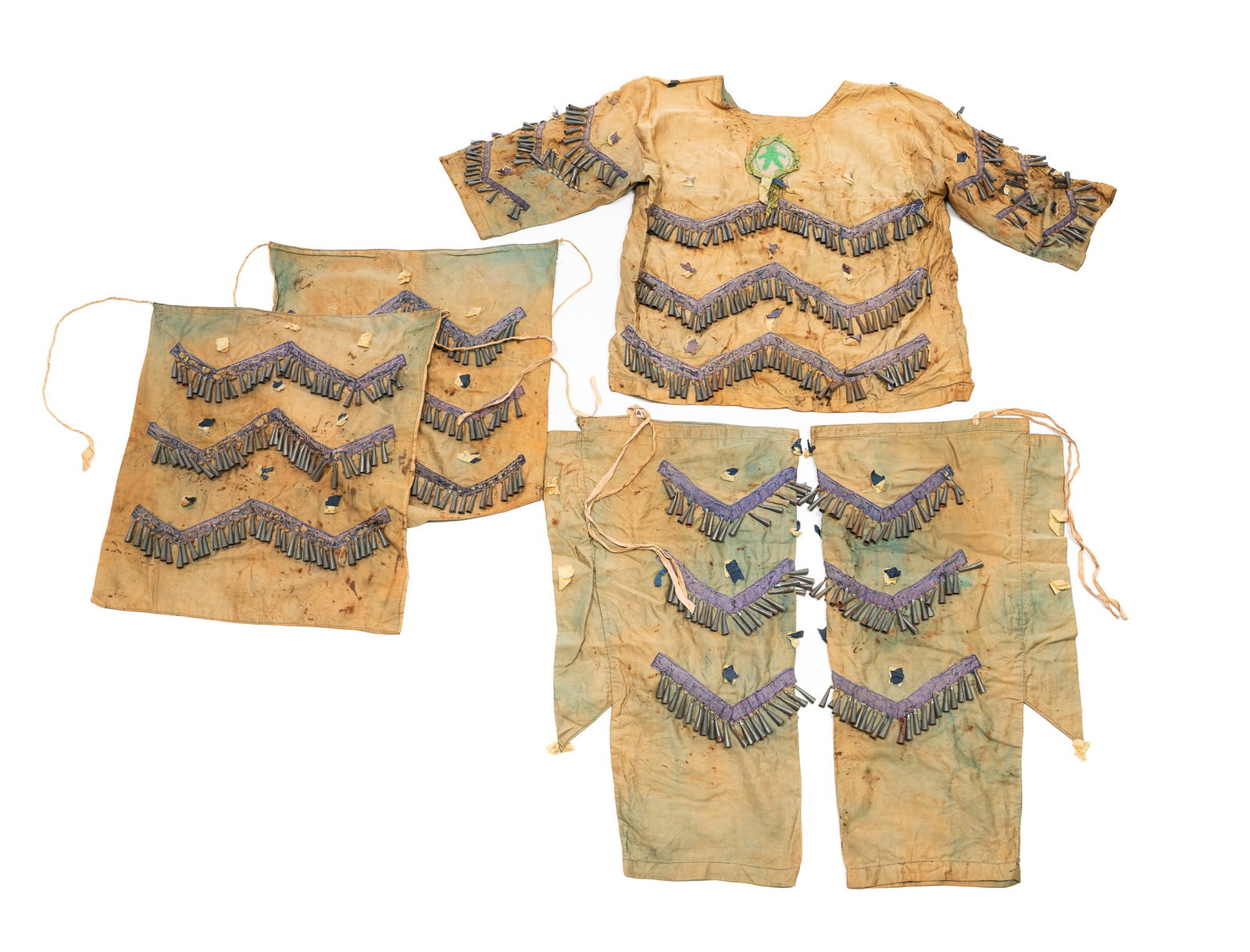 FIVE-PIECE NATIVE AMERICAN COSTUME.: FIVE-PIECE NATIVE AMERICAN COSTUME. Ca. 1900. Two leggings, two aprons, and a blouse. Faded green fabric with purple trim and tin conical-shaped fringe. Leggings, 23"l. Aprons, 18.5"h. 16.5"w.