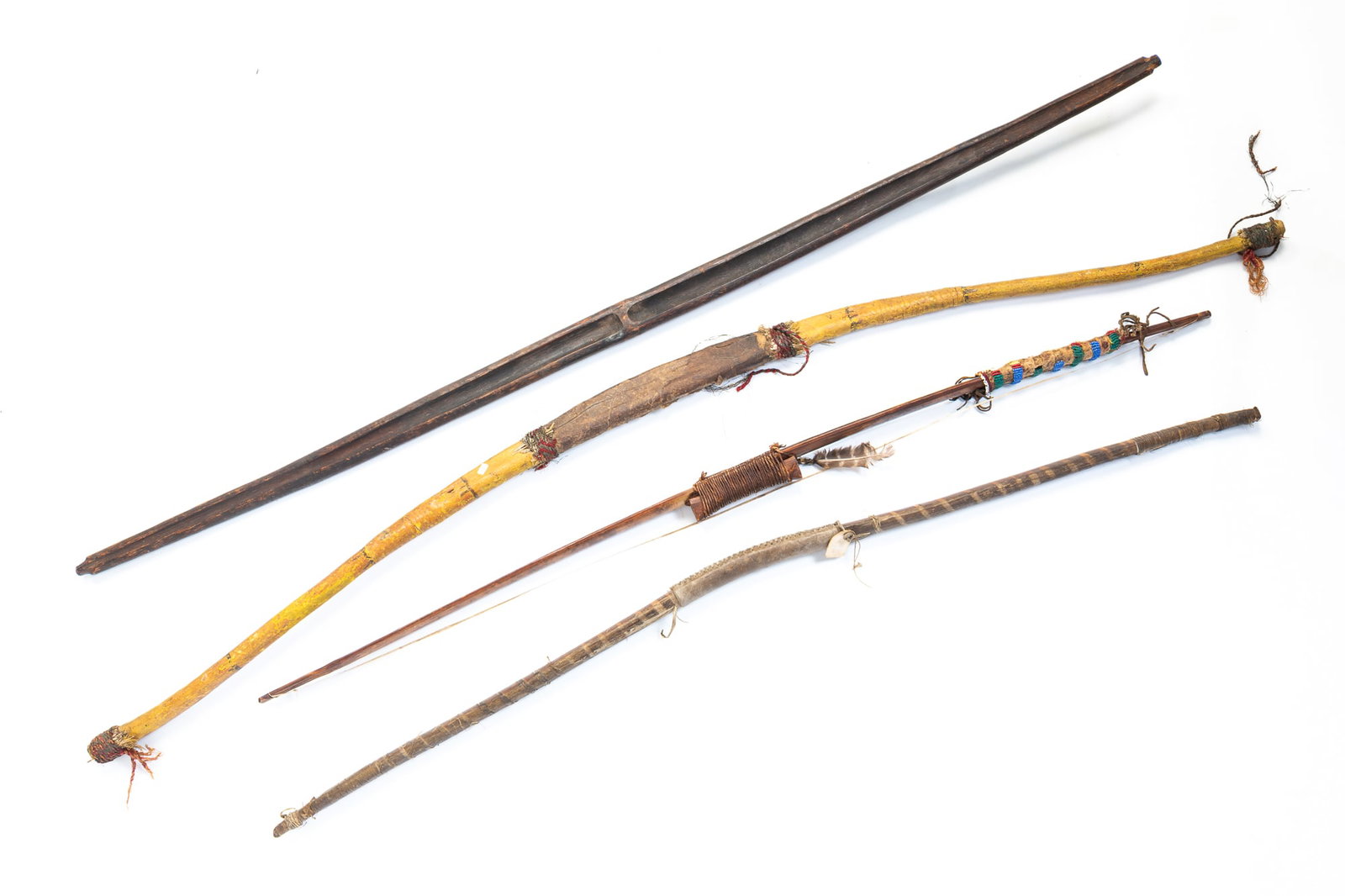 FOUR NATIVE AMERICAN LONG BOWS. (1 of 6)