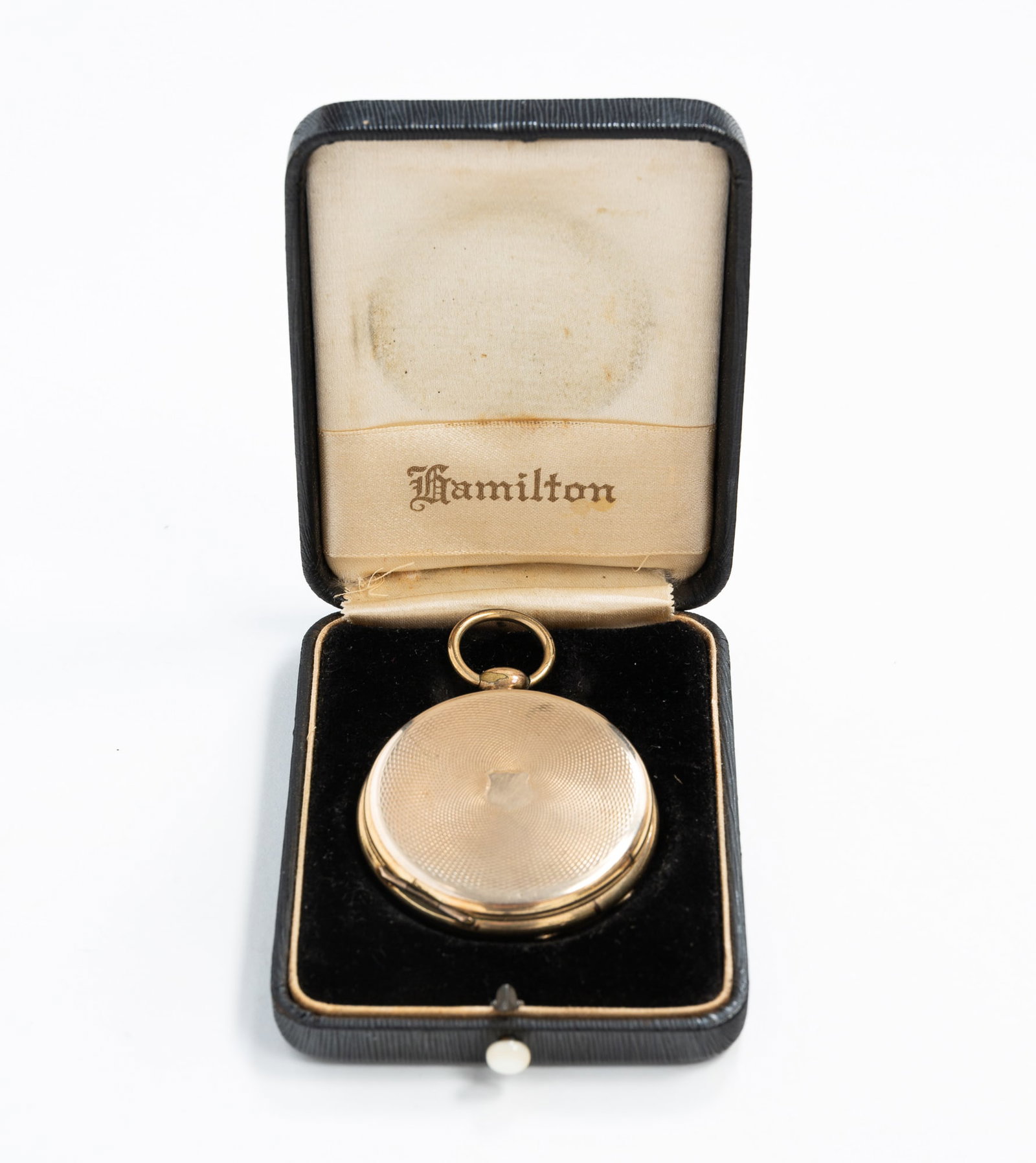 POCKET WATCH FORM LOCKET WITH FOUR DAGUERREOTYPES.: POCKET WATCH FORM LOCKET WITH FOUR DAGUERREOTYPES. American, Fourth quarter 19th Century. Circular locket that opens two ways swing out four daguerreotype portrait images. Gold-plated, patterned case.