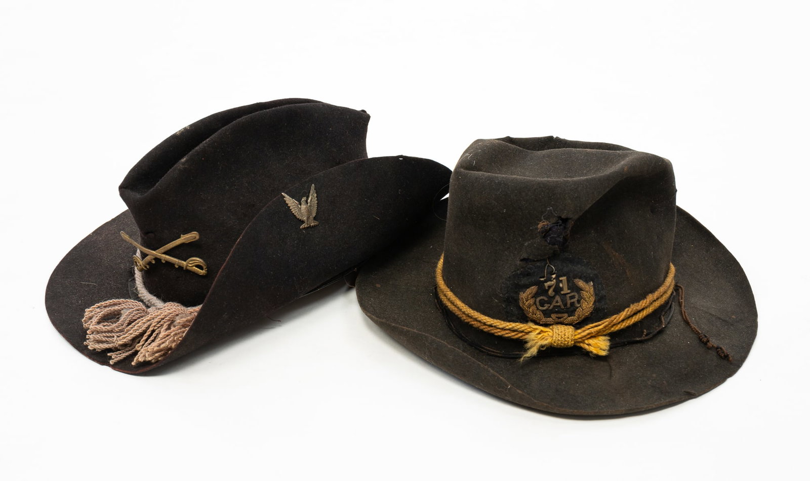 TWO AMERICAN FELT MILITARY HATS.: TWO AMERICAN FELT MILITARY HATS. 19th Century. The first a brown slouch hat with a Grand Army of the Republic emblem and the number 71, with a yellow cord, a leather sweatband, and holes in front and