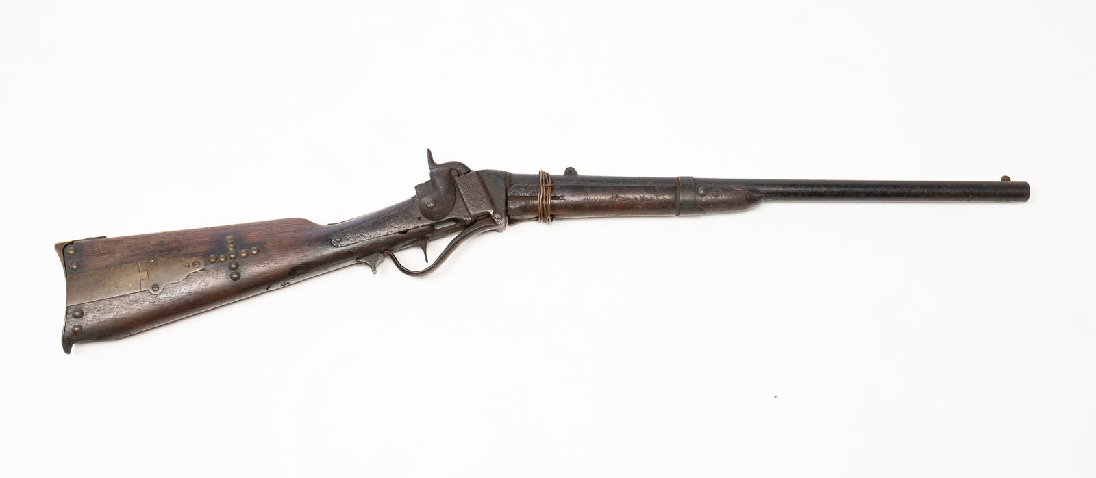 AMERICAN 1852 SHARPS CARBINE RELIC.: AMERICAN 1852 SHARPS CARBINE RELIC. Walnut stock and forearm, brass patchbox, brass tack decoration, round barrel, and steel hardware. Likely used in Indian Wars, 37.75"l. Provenance: From the Lifetim