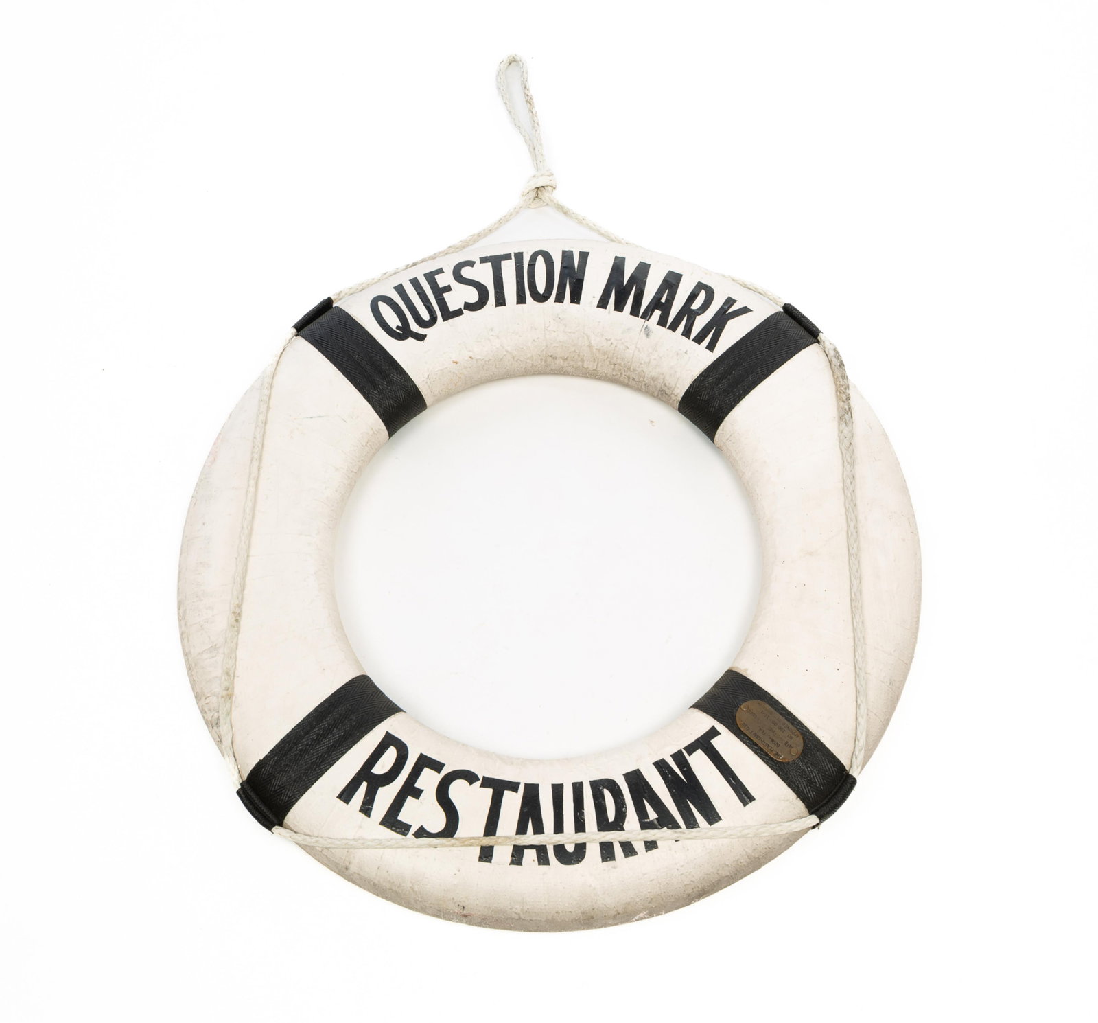"QUESTION MARK RESTAURANT" LIFE RING SIGN.: "QUESTION MARK RESTAURANT" LIFE RING SIGN. American, 1967. Marine life saver with rope, painted white with black lettering, having a brass plaque reading "The Plasti-Kraft Corp. Ozona, Fla. Date 3.67