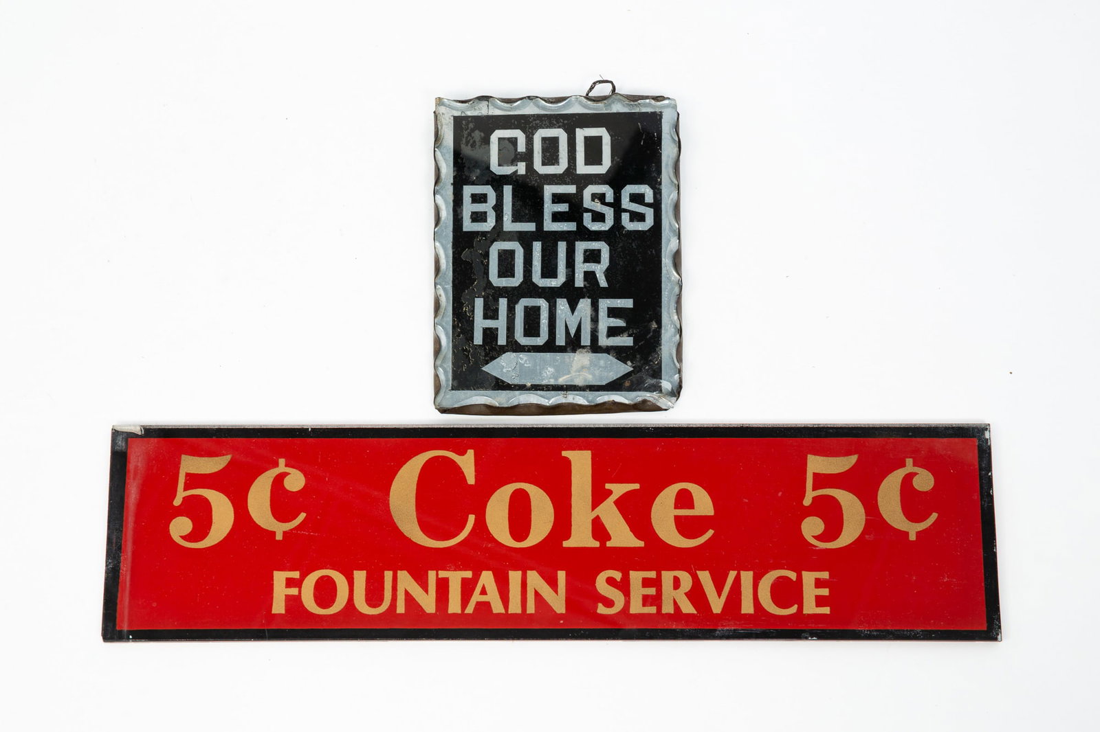 TWO GLASS SIGNS.: TWO GLASS SIGNS. American, 20th Century. A diminutive "GOD BLESS OUR HOME" in black and silver with scalloped edges and tin backing, 6.25"h. 4.75"w., together with a "5 cent COKE 5 cent/FOUNTAIN