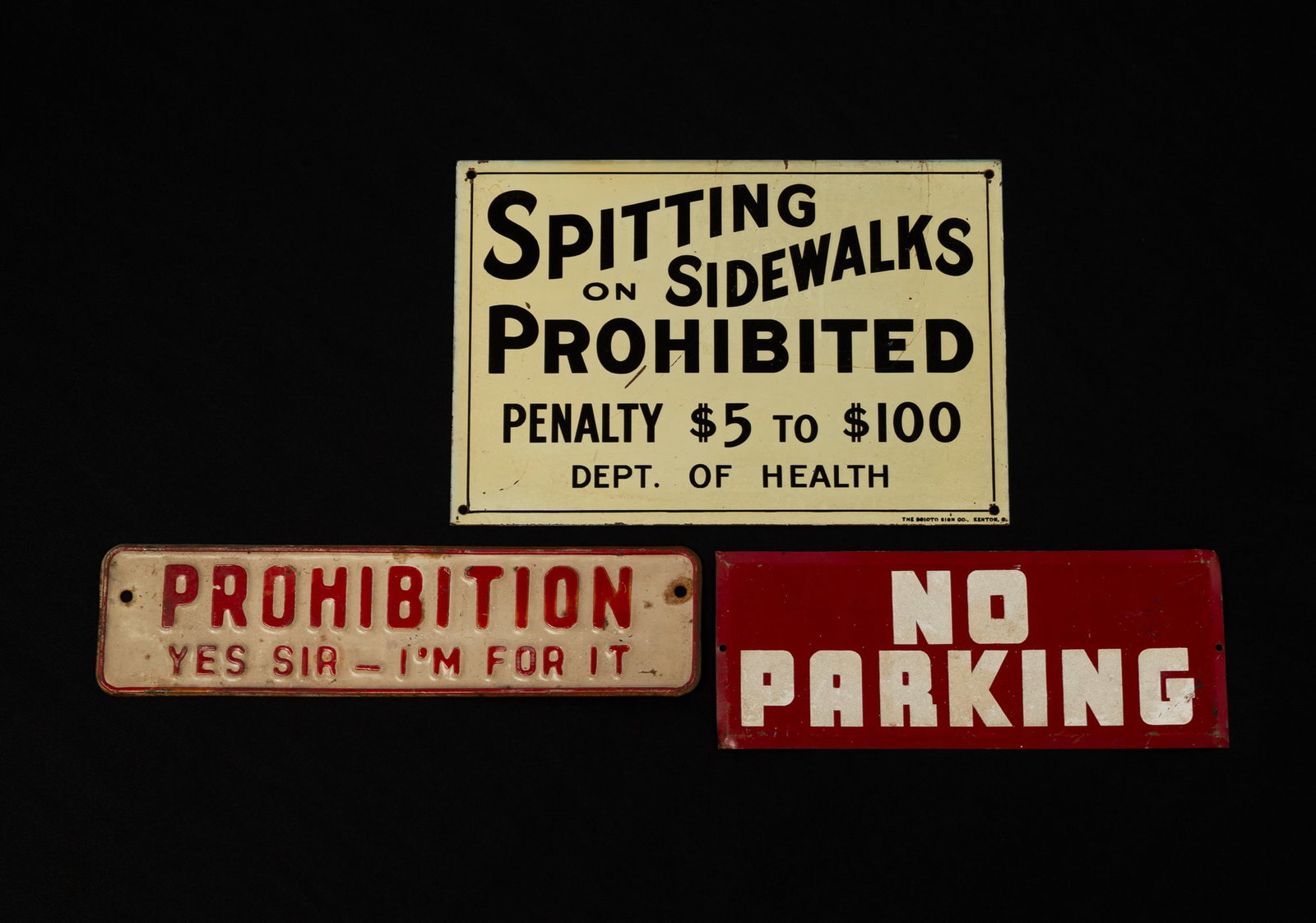 THREE AMERICAN PAINTED TIN SIGNS.: THREE AMERICAN PAINTED TIN SIGNS. 20th Century. White with black lettering "SPITTING ON SIDEWALKS PROHIBITED, PENALTY $5 TO $100, DEPT. OF HEALTH" by Scioto Sign Company, Kenton, Ohio, 6.75"h 10"w.,
