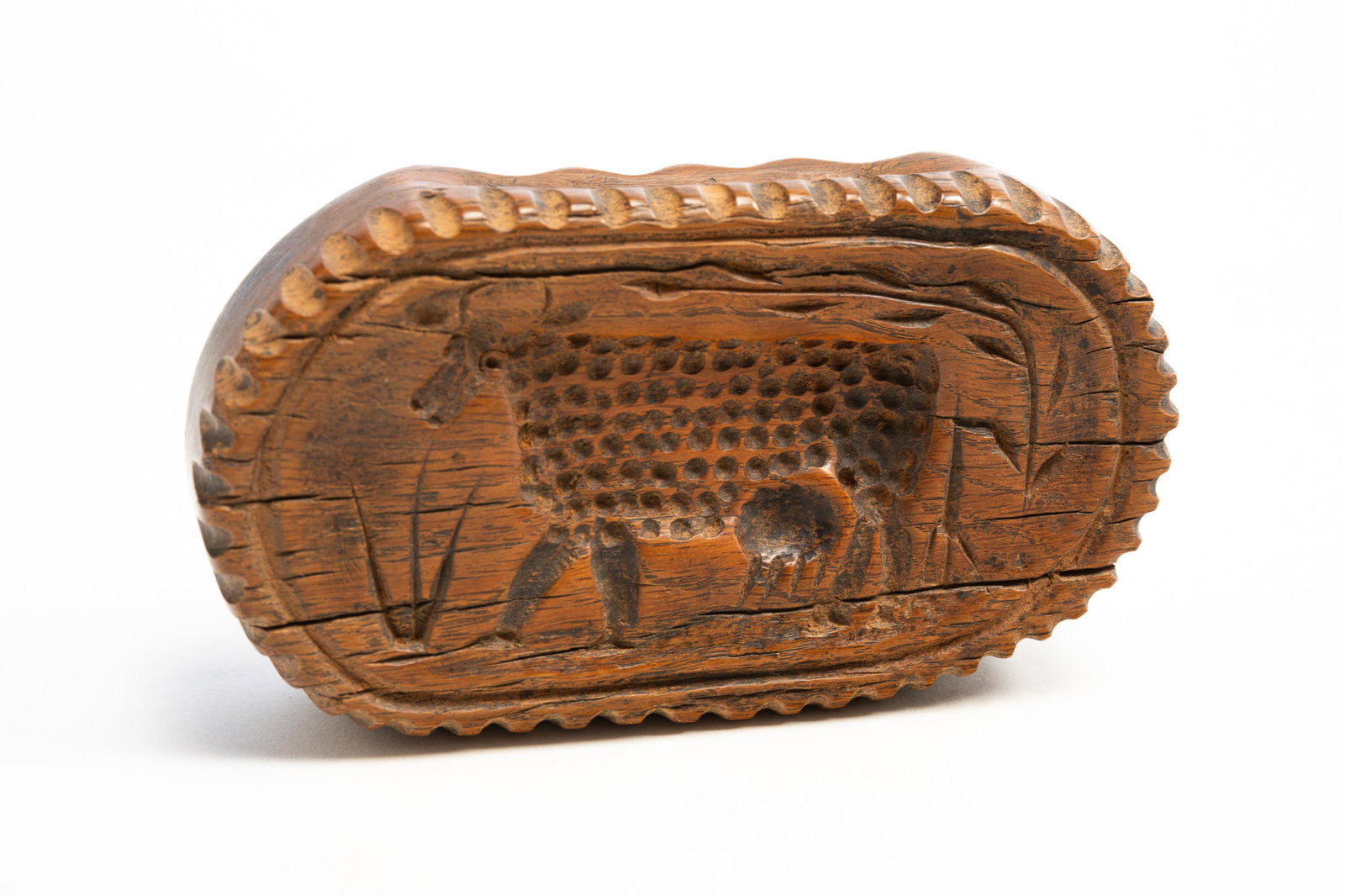 SCARCE LARGE BUTTERPRINT WITH CARVED COW.: SCARCE LARGE BUTTERPRINT WITH CARVED COW. American, Early 19th Century. Rectangular form with full-bodied cow carving flanked by a tree on the right and tall grass on the left. With hewn grips,