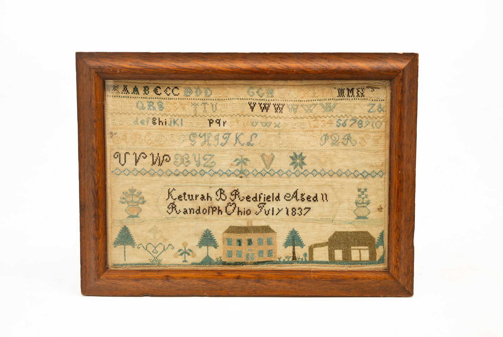 OHIO NEEDLEWORK SAMPLER WROUGHT BY KETURAH REDFIELD.: OHIO NEEDLEWORK SAMPLER WROUGHT BY KETURAH REDFIELD. American, 19th Century. Polychrome thread on linen. Rows of alphabets and numerals, eight-point star, flower, and heart, and signed "Ketura B.