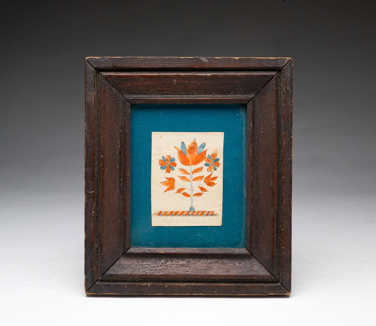 MINIATURE FRAMED WATERCOLOR OF FLOWERS.: MINIATURE FRAMED WATERCOLOR OF FLOWERS. American, 19th Century. Depicting a tulip on a large, leafy stem flanked by flowers, with a mat backing in a period frame behind glass. Frame, 9.25"h. 8"w.