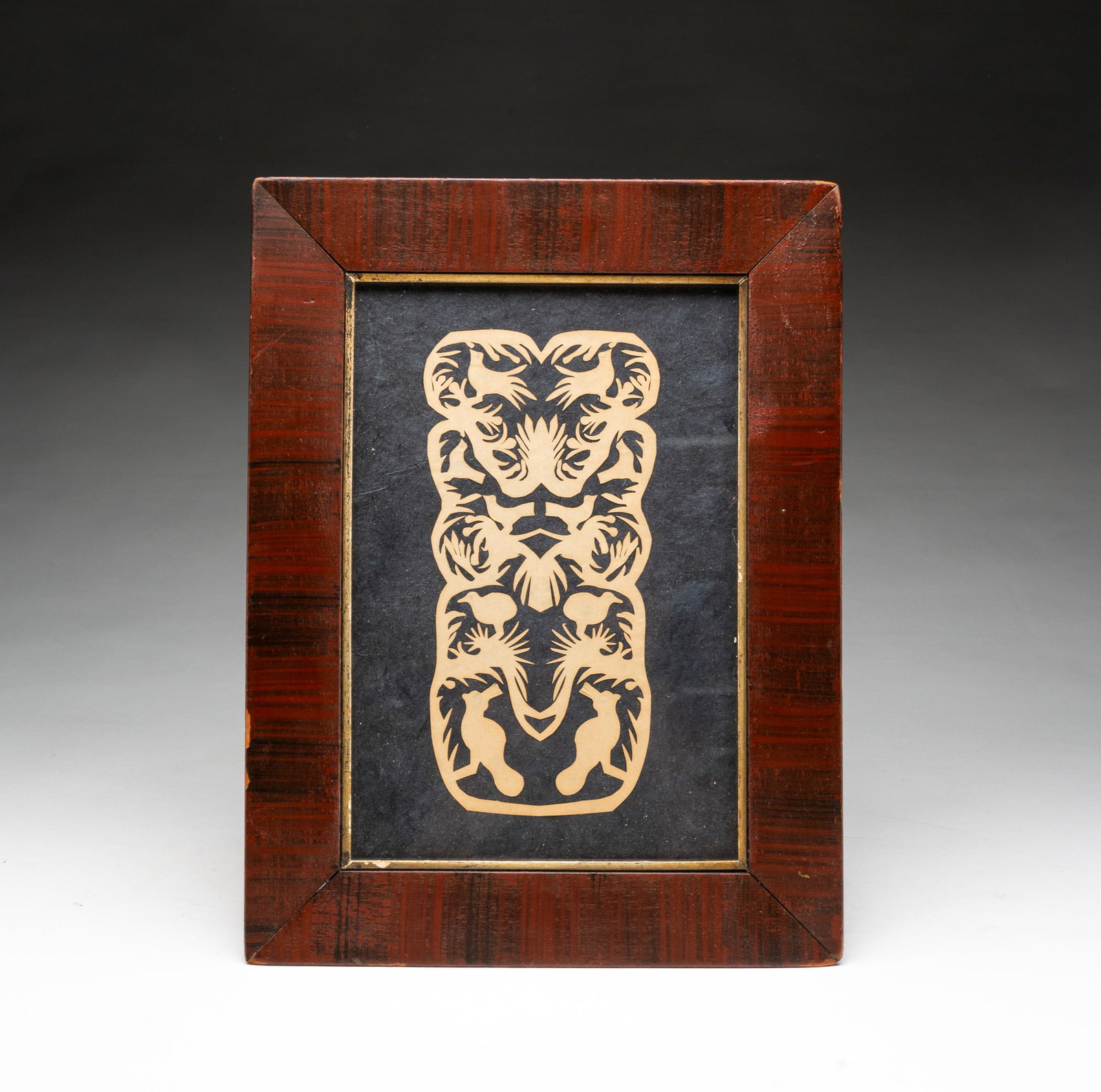 FOLKSY INTRICATELY CUT PAPER SCHERENSCHNITTE.: FOLKSY INTRICATELY CUT PAPER SCHERENSCHNITTE. American, 19th Century. Of vertical oblong shape extensively pierce-cut with various bird species in a tree. In a period veneered frame with gilt liner,