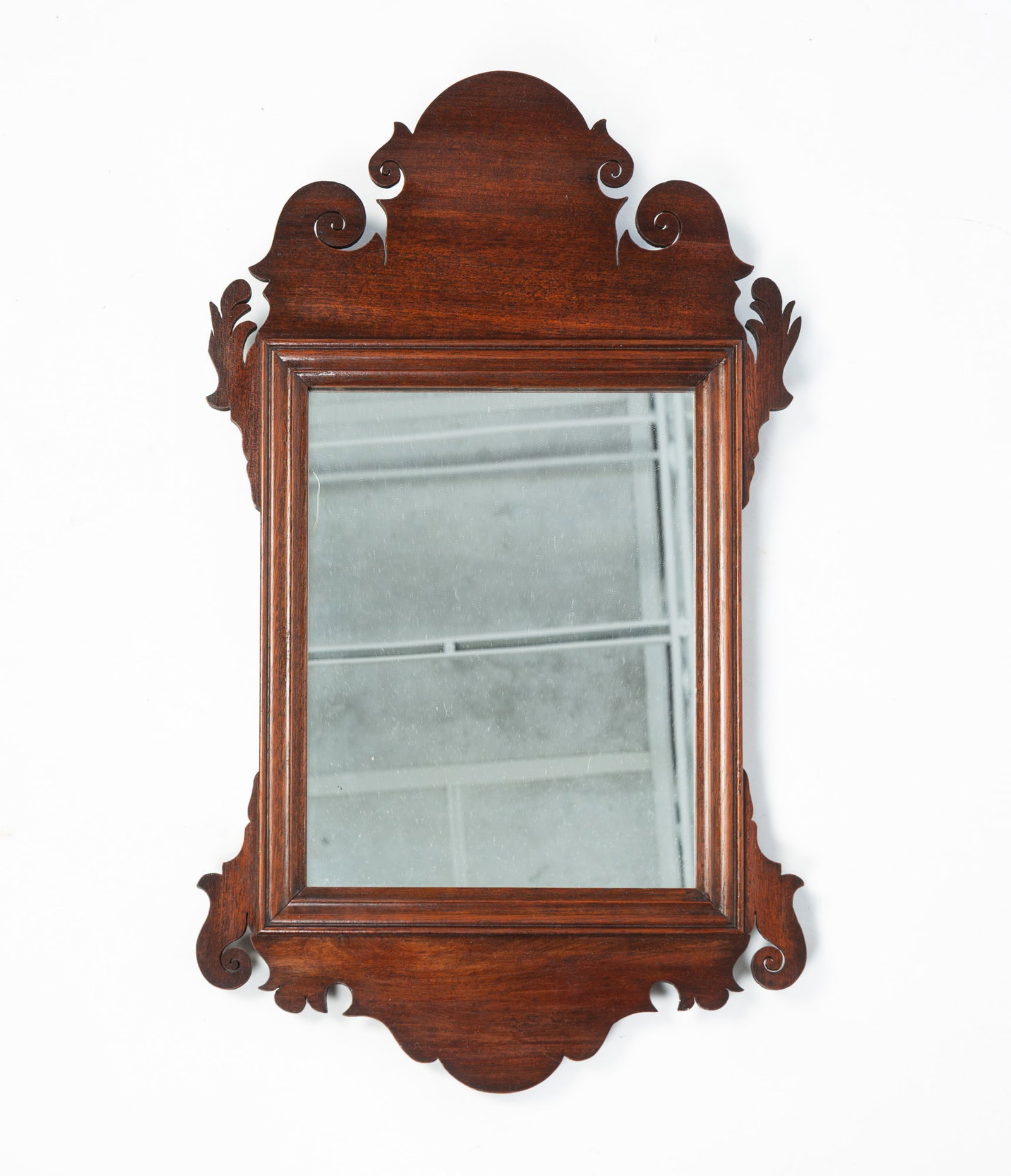 DIMINUTIVE MAHOGANY CHIPPENDALE SCROLL MIRROR.: DIMINUTIVE MAHOGANY CHIPPENDALE SCROLL MIRROR. American, Late 18th Century. Nicely shaped scrolling and reeded frame around the mirror. 20"h. 12"w. Provenance: From the Lifetime Collection of Charles 