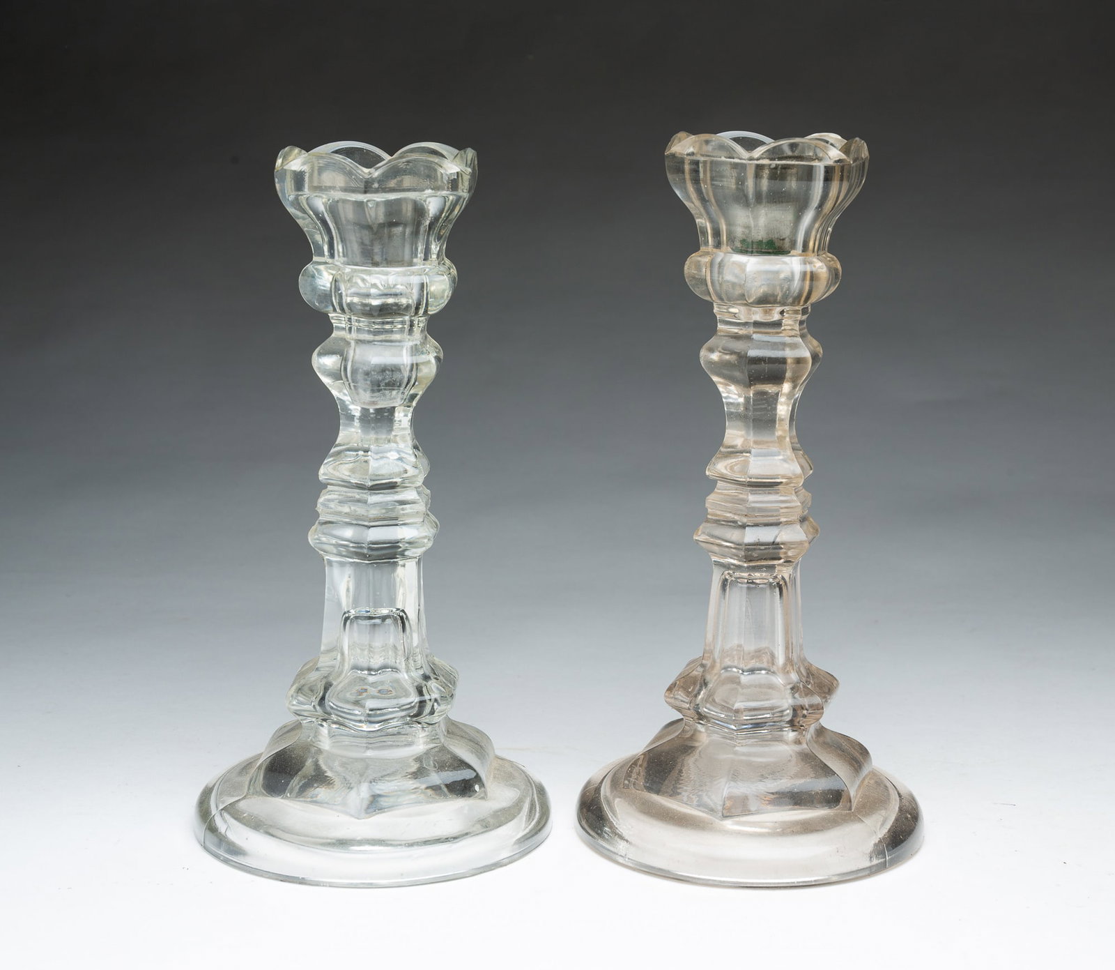 A PAIR OF PITTSBURGH FLINT GLASS CANDLESTICKS WITH PEWTER INSERTS.: A PAIR OF PITTSBURGH FLINT GLASS CANDLESTICKS WITH PEWTER INSERTS. American, Mid-19th Century. Clear glass in nice condition. 9.5"h. Provenance: The Lifetime Collection of Martha Magsig Lynch
