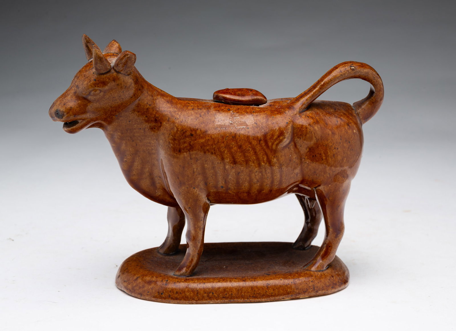 ROCKINGHAM FIGURAL BUFF CLAY COW CREAMER. (1 of 3)