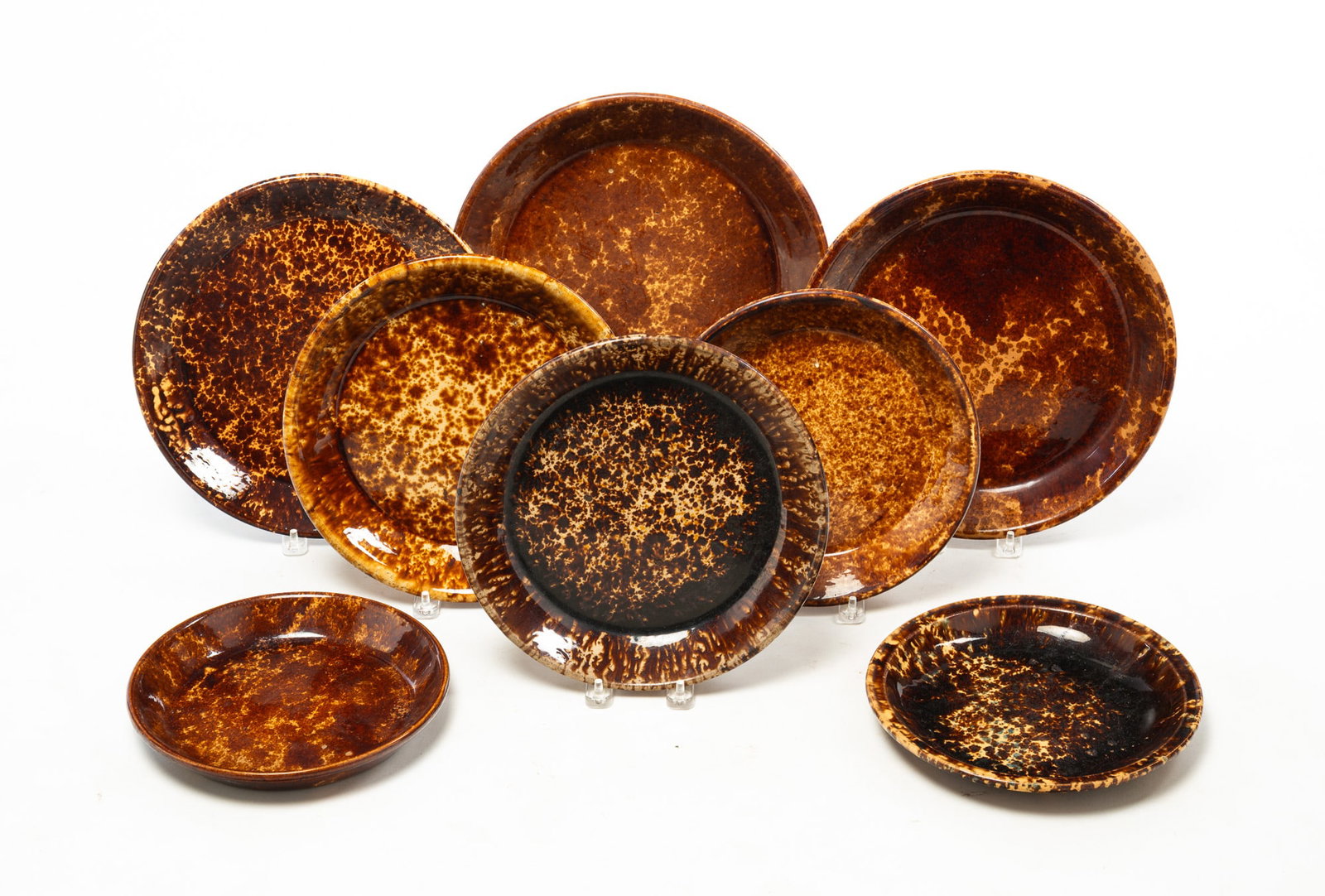 EIGHT ROCKINGHAM GLAZED PIE PLATES AND DISHES.: EIGHT ROCKINGHAM GLAZED PIE PLATES AND DISHES. American, 19th Century. Includes pie plates in a variety of sizes. From 12"d. to 8.5"d. Provenance: From the Lifetime Collection of Charles and Margaret 