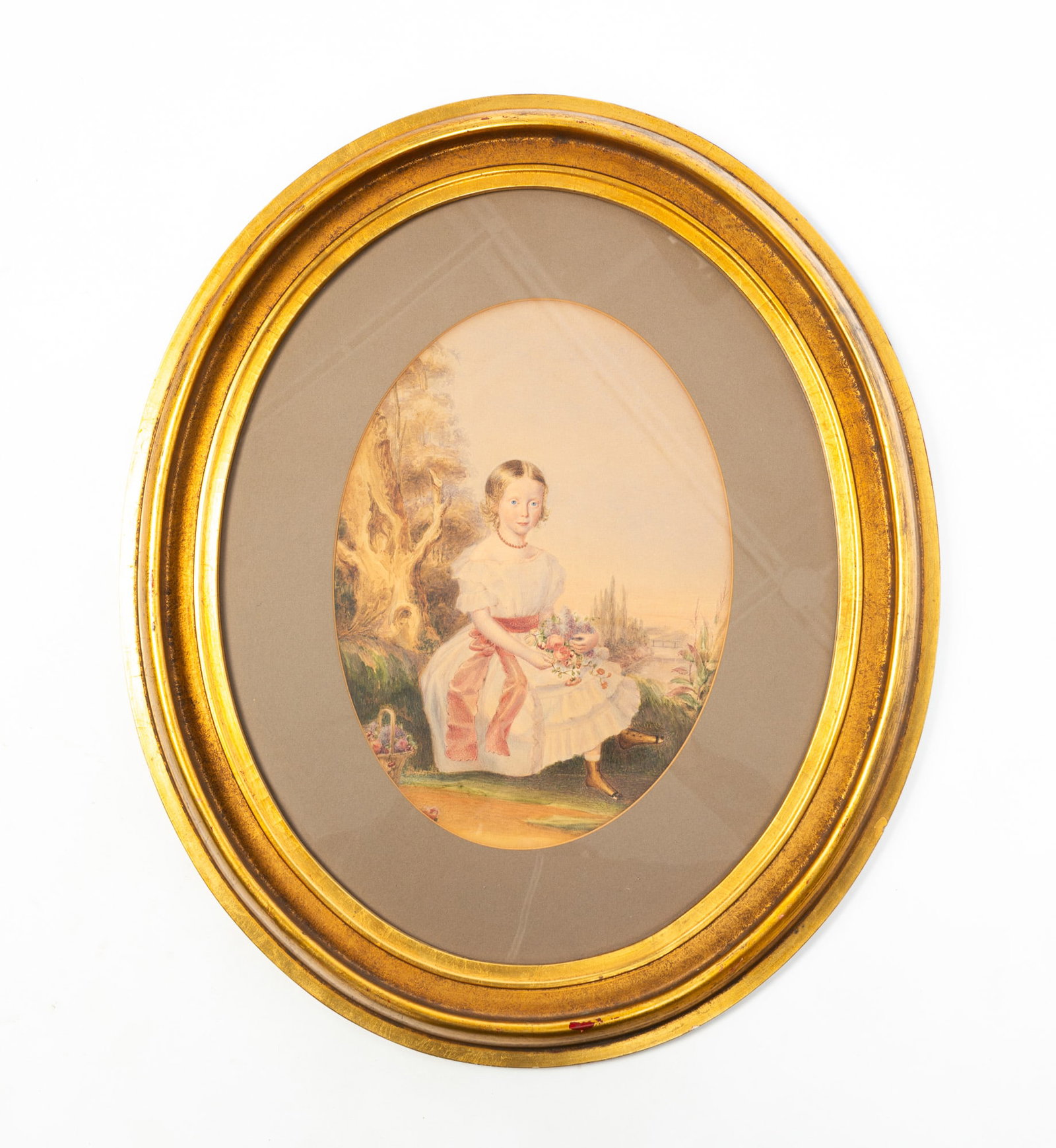 WATERCOLOR PORTRAIT OF A GIRL IN LANDSCAPE WITH FLOWERS.: WATERCOLOR PORTRAIT OF A GIRL IN LANDSCAPE WITH FLOWERS. American, 19th Century. Depicting a girl wearing a white dress with red necklace and red sash holding a bunch of flowers, sitting on a grassy