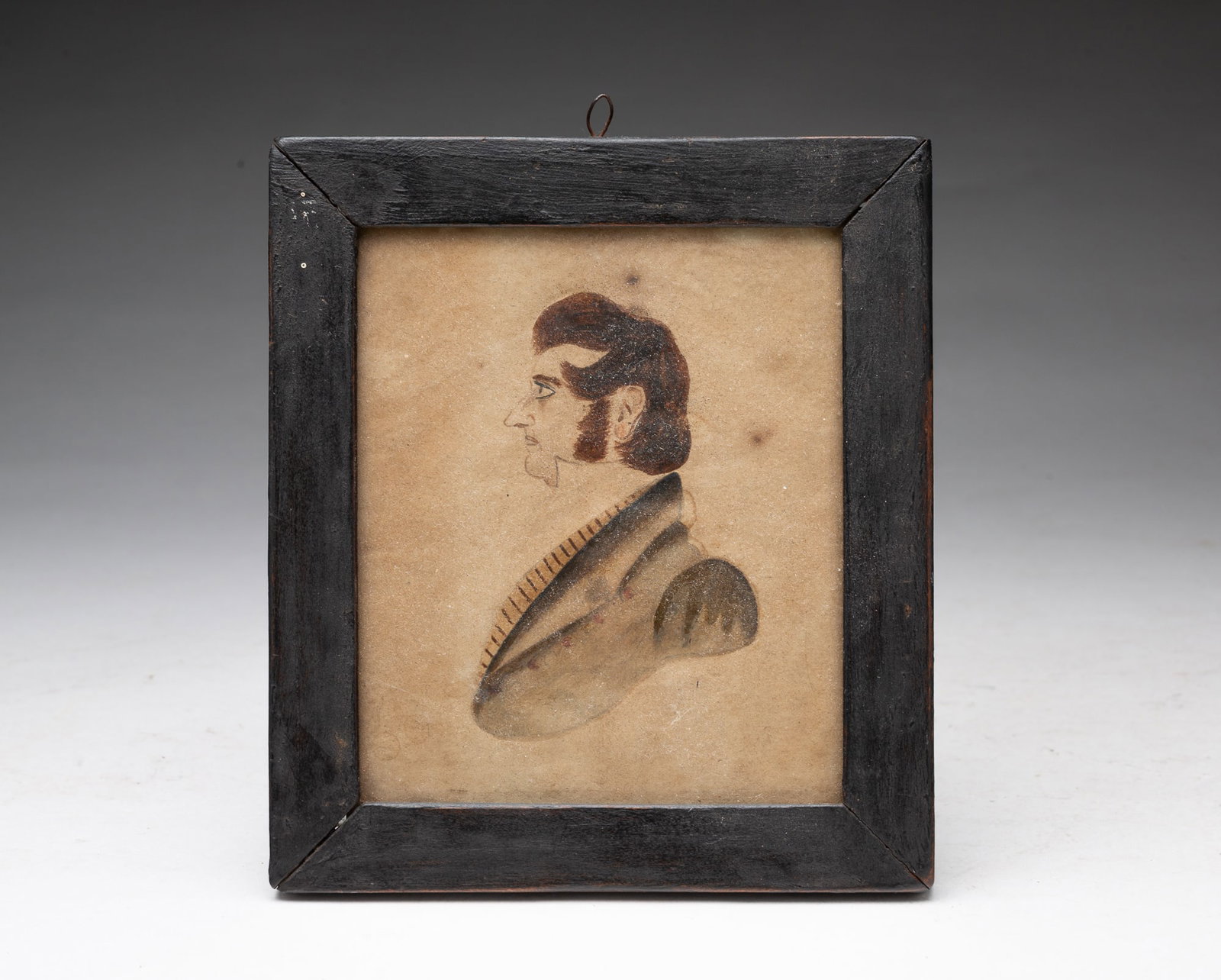 MINIATURE WATERCOLOR PORTRAIT OF A GENTLEMAN.: MINIATURE WATERCOLOR PORTRAIT OF A GENTLEMAN. American, 19th Century. Profile bust of a gentleman with his reddish-brown hair swept forward with bushy sideburns, wearing a white high-collared shirt, s