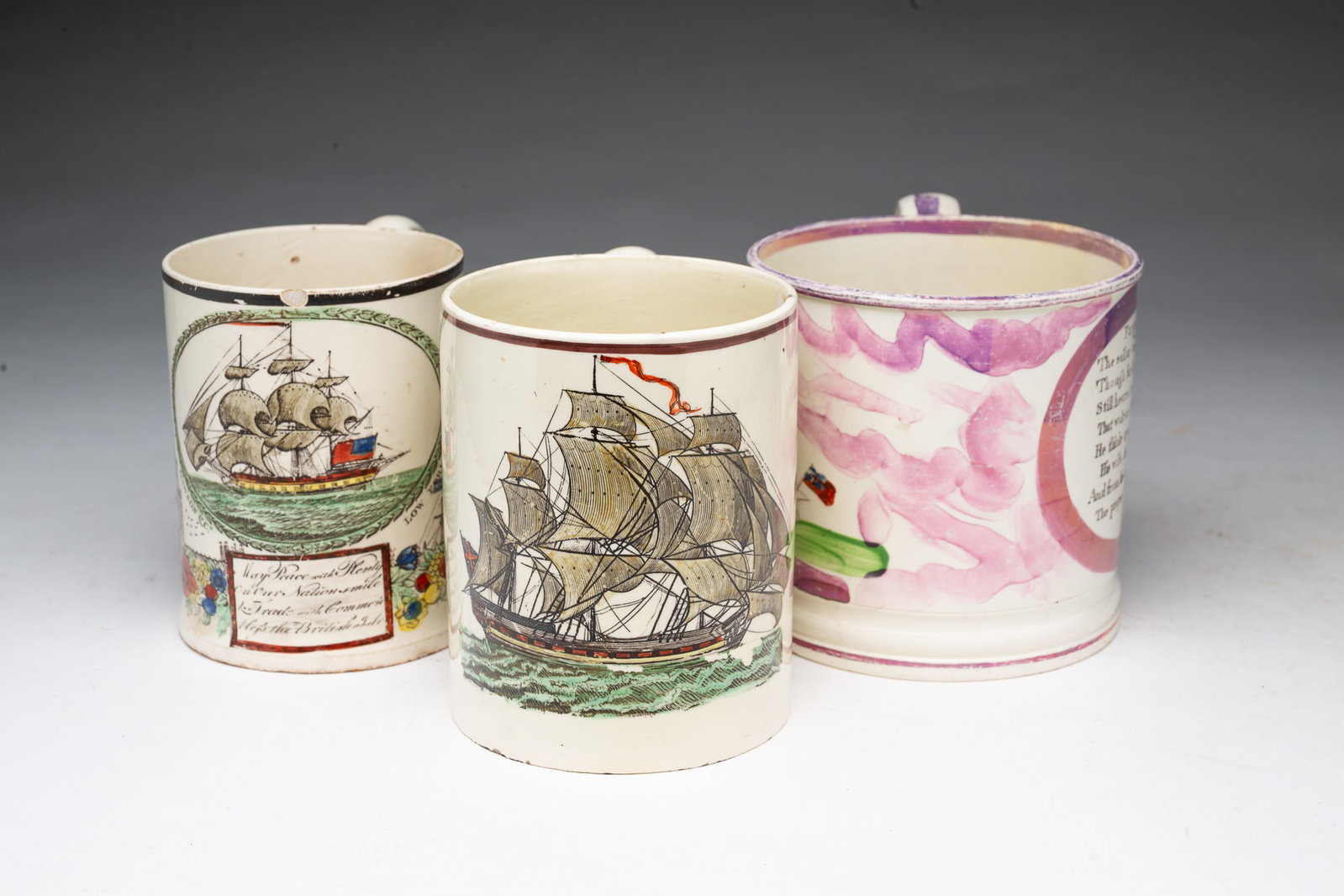THREE PEARLWARE MUGS.: THREE PEARLWARE MUGS. England, 19th Century. A Sunderland luster mug with "Forget me not" saying and a hand-colored transfer of ship "Northumberland 74", 4.25"h., a mug with a brown trim and a hand