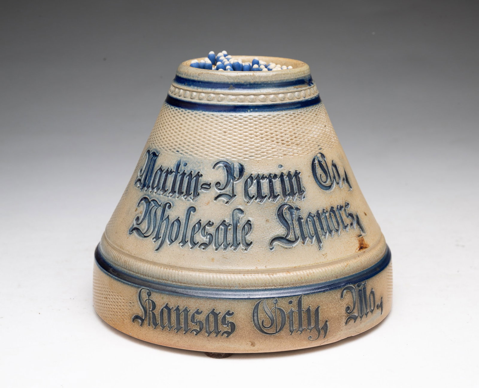 ATTRIBUTED TO WHITE'S POTTERY (UTICA, NEW YORK) LARGE STONEWARE MATCH SAFE AND STRIKER.: ATTRIBUTED TO WHITE'S POTTERY (UTICA, NEW YORK) LARGE STONEWARE MATCH SAFE AND STRIKER. American, Late 19th or Early 20th Century. Conical form with cobalt decoration, and impressed "Martin-Perrin Co.