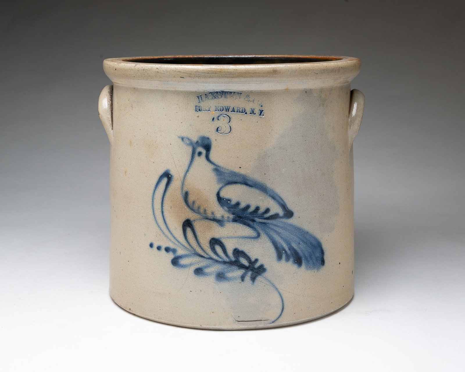 HAXSTON & CO. (FORT EDWARD, NEW YORK) FREEHAND COBALT DECORATED STONEWARE CROCK WITH BIRD.: HAXSTON & CO. (FORT EDWARD, NEW YORK) FREEHAND COBALT DECORATED STONEWARE CROCK WITH BIRD. American, 19th Century. Of cylindrical form, semi-squared lip, applied lug handles, impressed maker's and cap