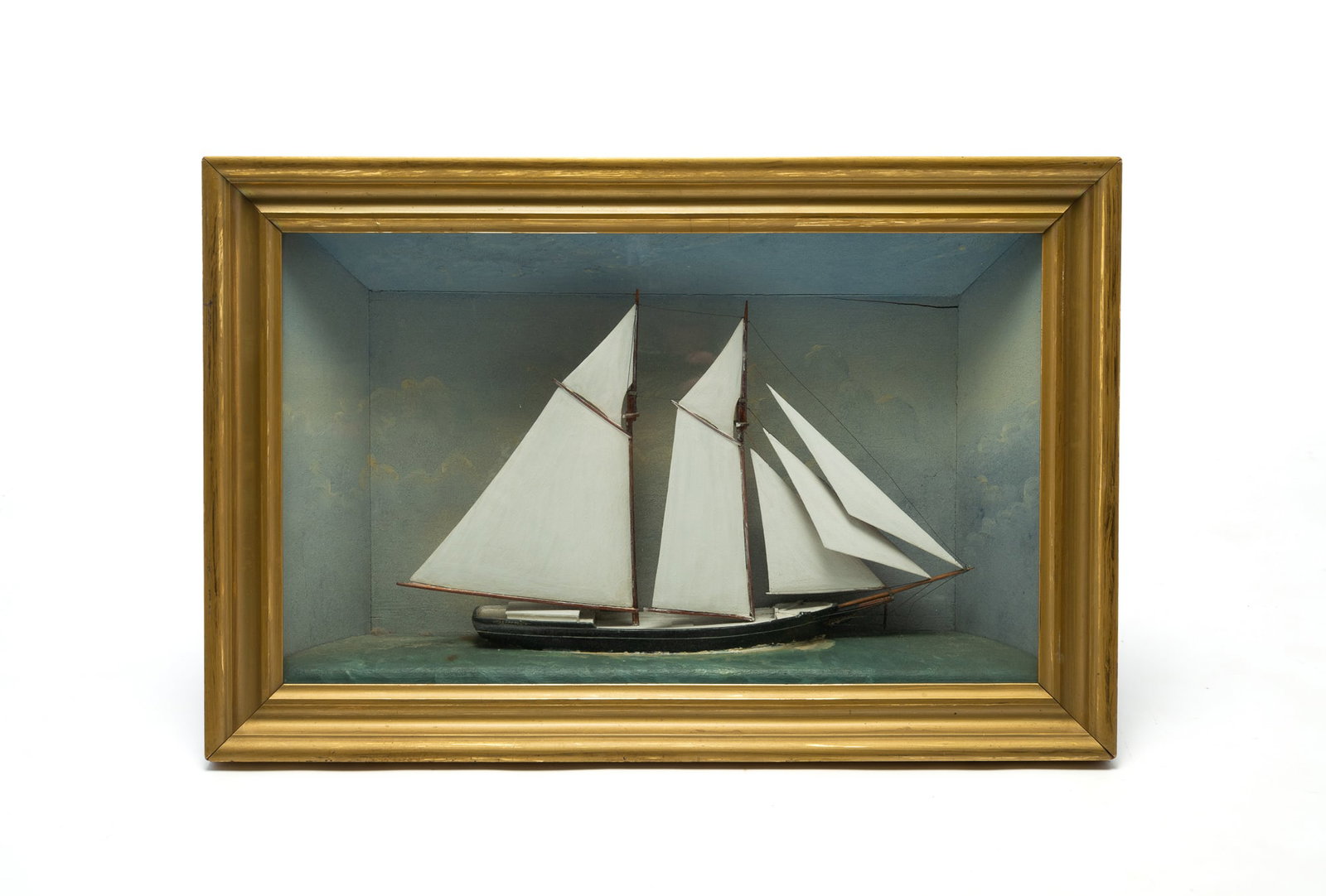 FRAMED SAILING SHIP DIORAMA.: FRAMED SAILING SHIP DIORAMA. American, 20th Century. Three-dimensional sailing ship in a rectangular wood frame with gilt finish. The ship features multiple sails with detailed rigging and a painted