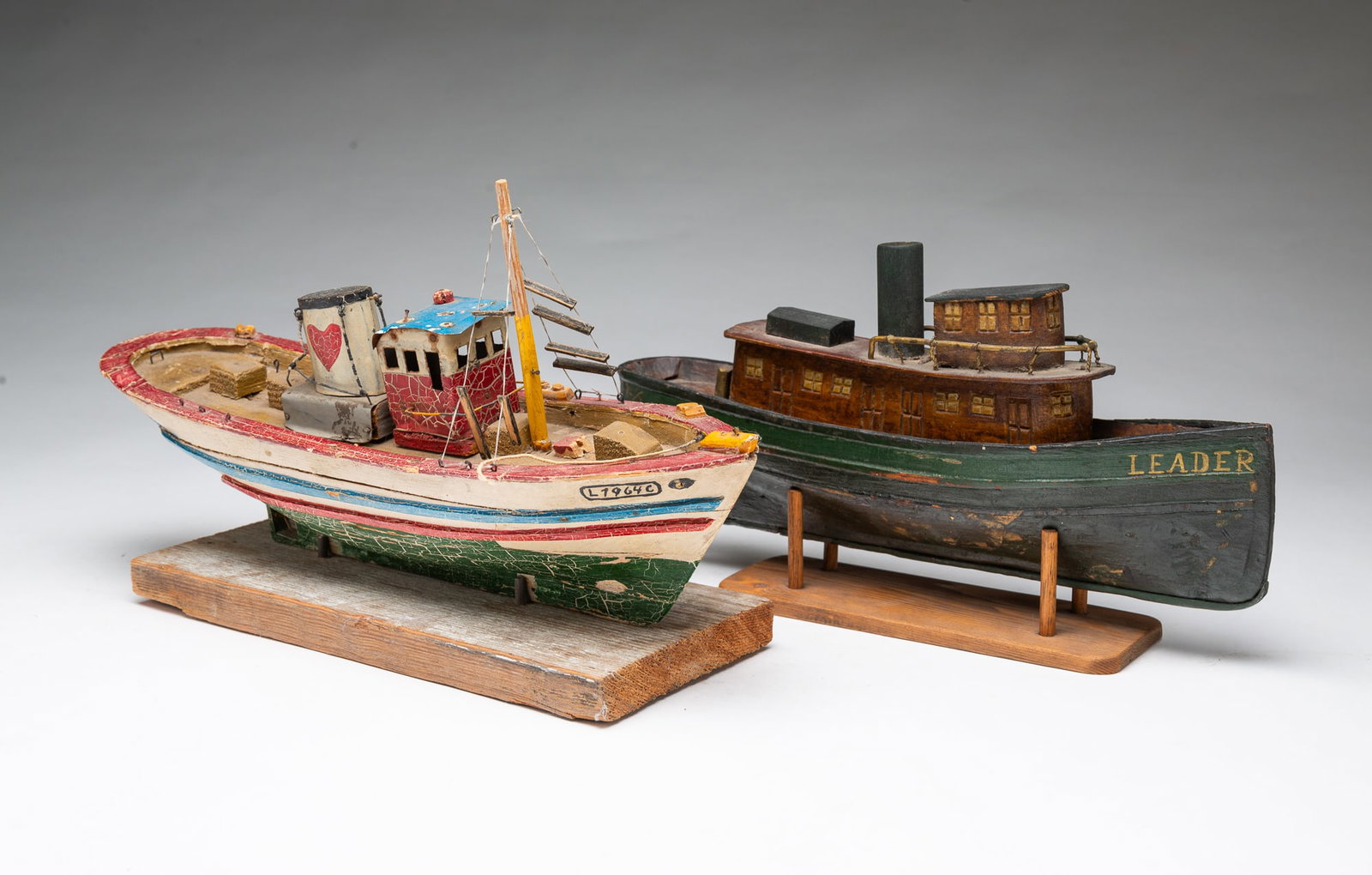TWO DIMINUTIVE WOODEN SHIP MODELS, LEADER AND PARDELA.: TWO DIMINUTIVE WOODEN SHIP MODELS, LEADER AND PARDELA. American, Late 19th or Early 20th Century. The Leader exhibits an aged green and wood-tone finish with detailed windows and railings on a wooden
