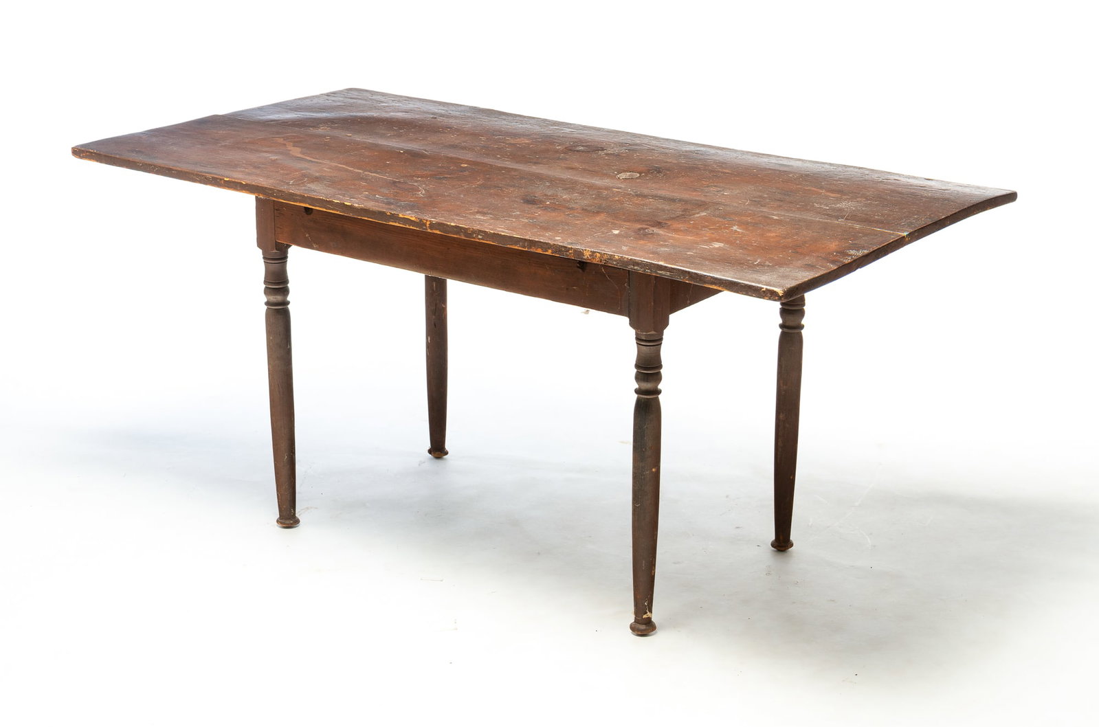 BROWN PAINTED FARM TABLE WITH TURNED LEGS.: BROWN PAINTED FARM TABLE WITH TURNED LEGS. American, 19th Century. Two board top on a base with turned legs. Old, but not original, dark brown painted surface. 25.5"h. 55"w. 28.75"d. Provenance: The