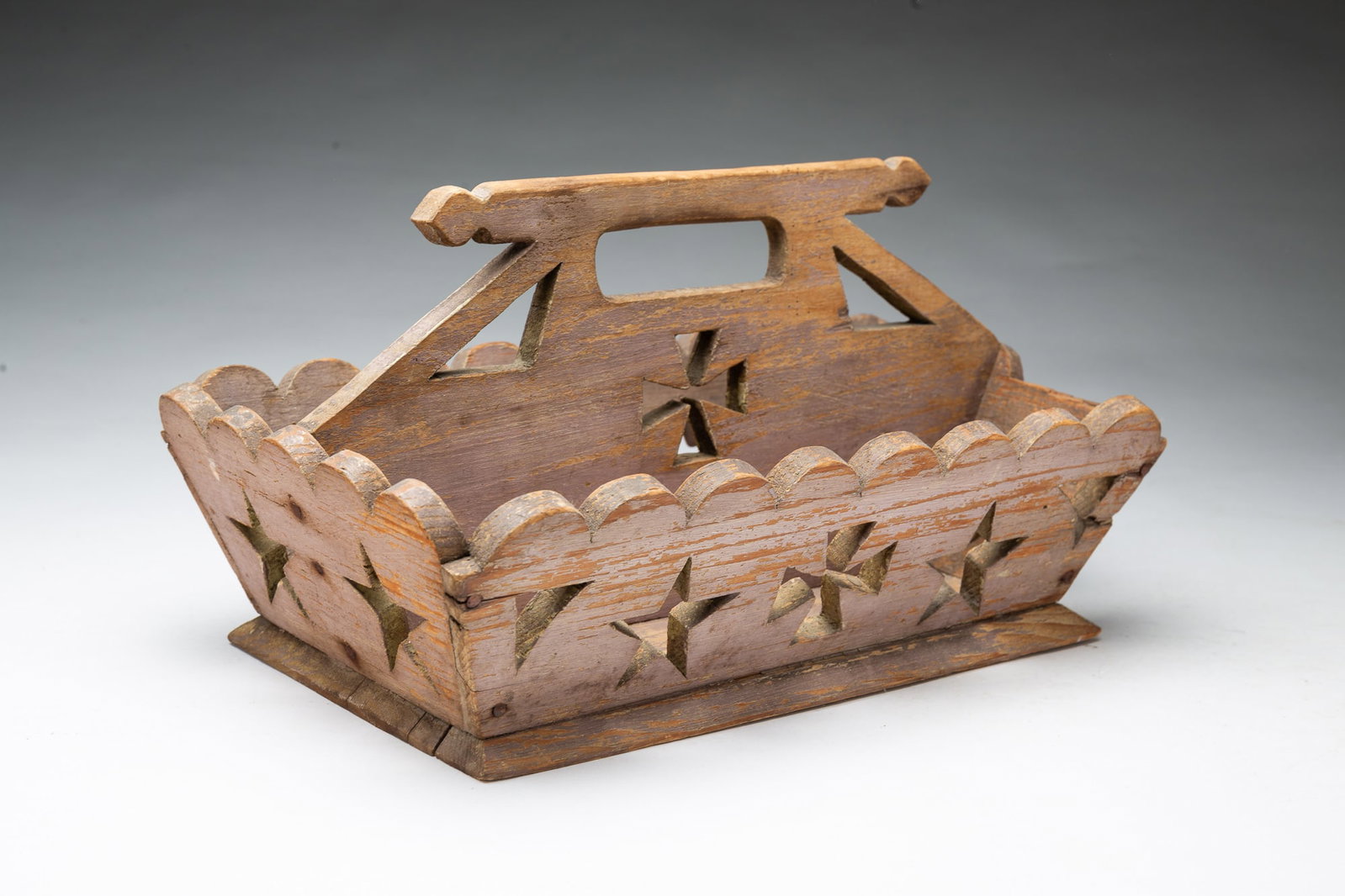 FOLK ART CARVED AND PIERCED CUTLERY TRAY WITH STARS AND CROSSES IN ORIGINAL LAVENDER PAINT.: FOLK ART CARVED AND PIERCED CUTLERY TRAY WITH STARS AND CROSSES IN ORIGINAL LAVENDER PAINT. American, 19th Century. Pine. Rectangular form with canted sides with scalloped edges and cutout stars,