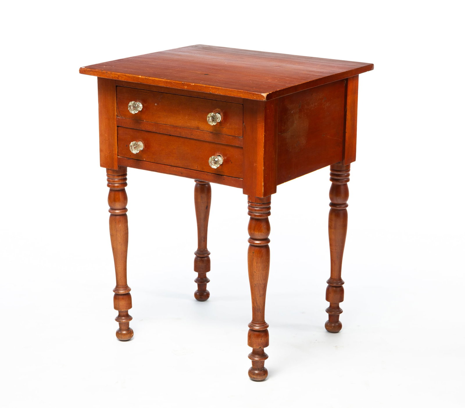 SHERATON CHERRY TWO-DRAWER STAND.: SHERATON CHERRY TWO-DRAWER STAND. American, Second quarter 19th Century. One board top, dovetailed drawers, and turned legs. 29.25"h. 22.25"w. 20"d. Provenance: From the Lifetime Collection of Gordon 